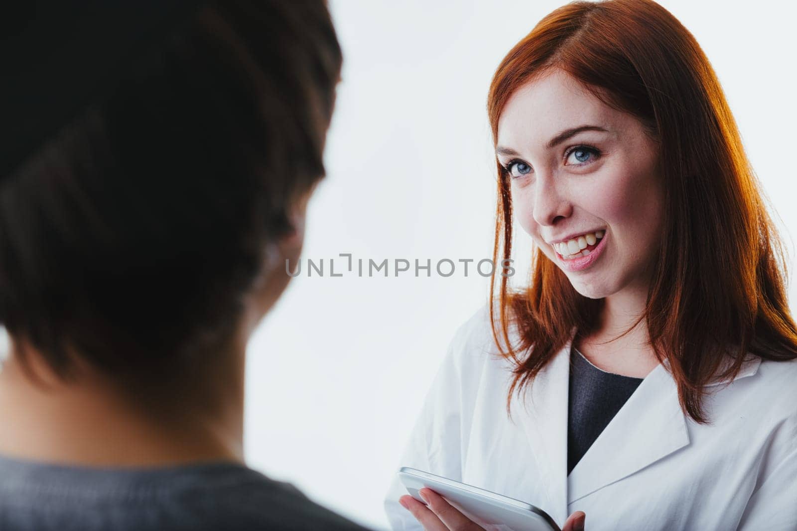 friendly medical consultation in progress, where technology meets compassion through the provider's engaging smile