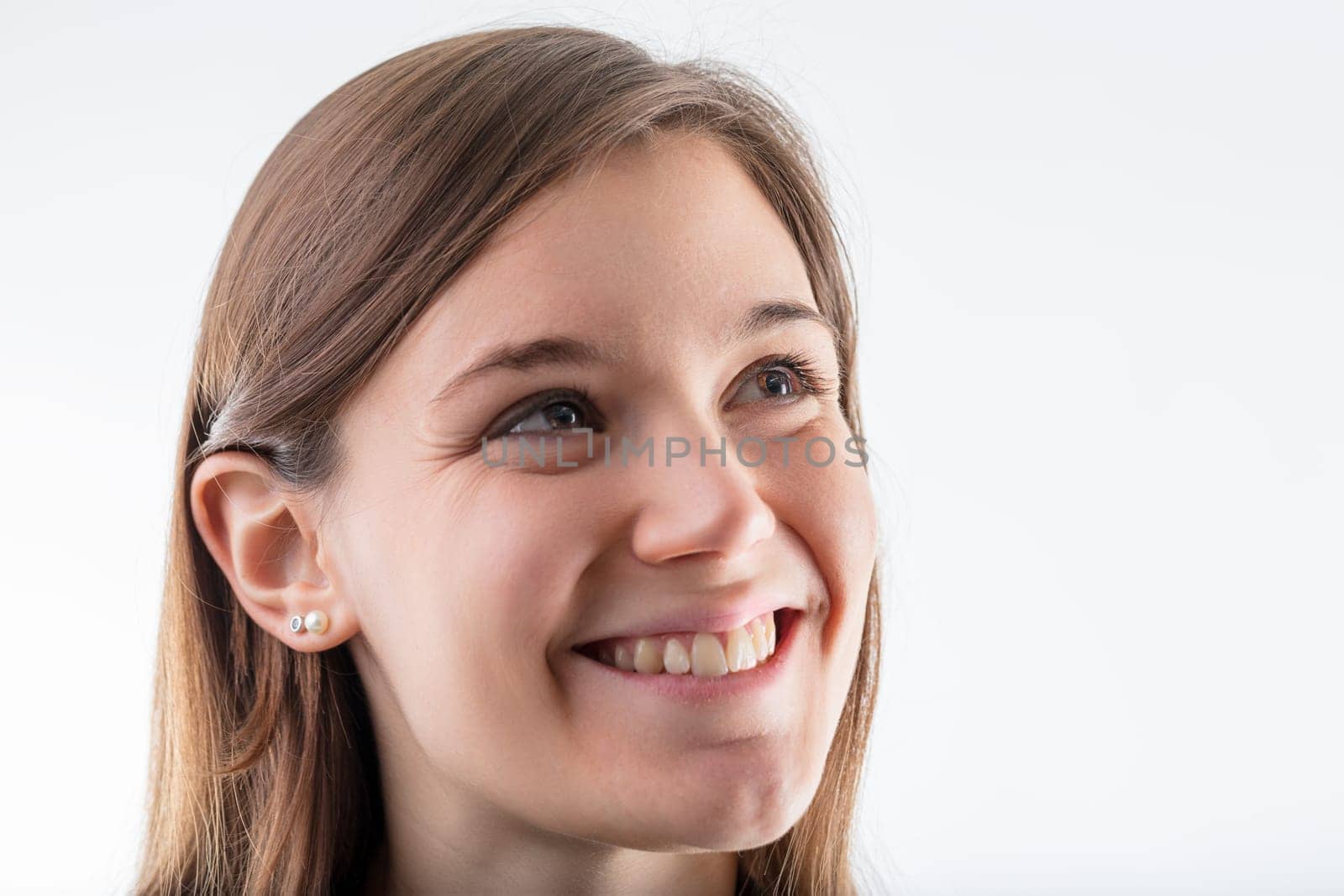 Young female's cheerful countenance and bright smile illuminate her light-hearted spirit