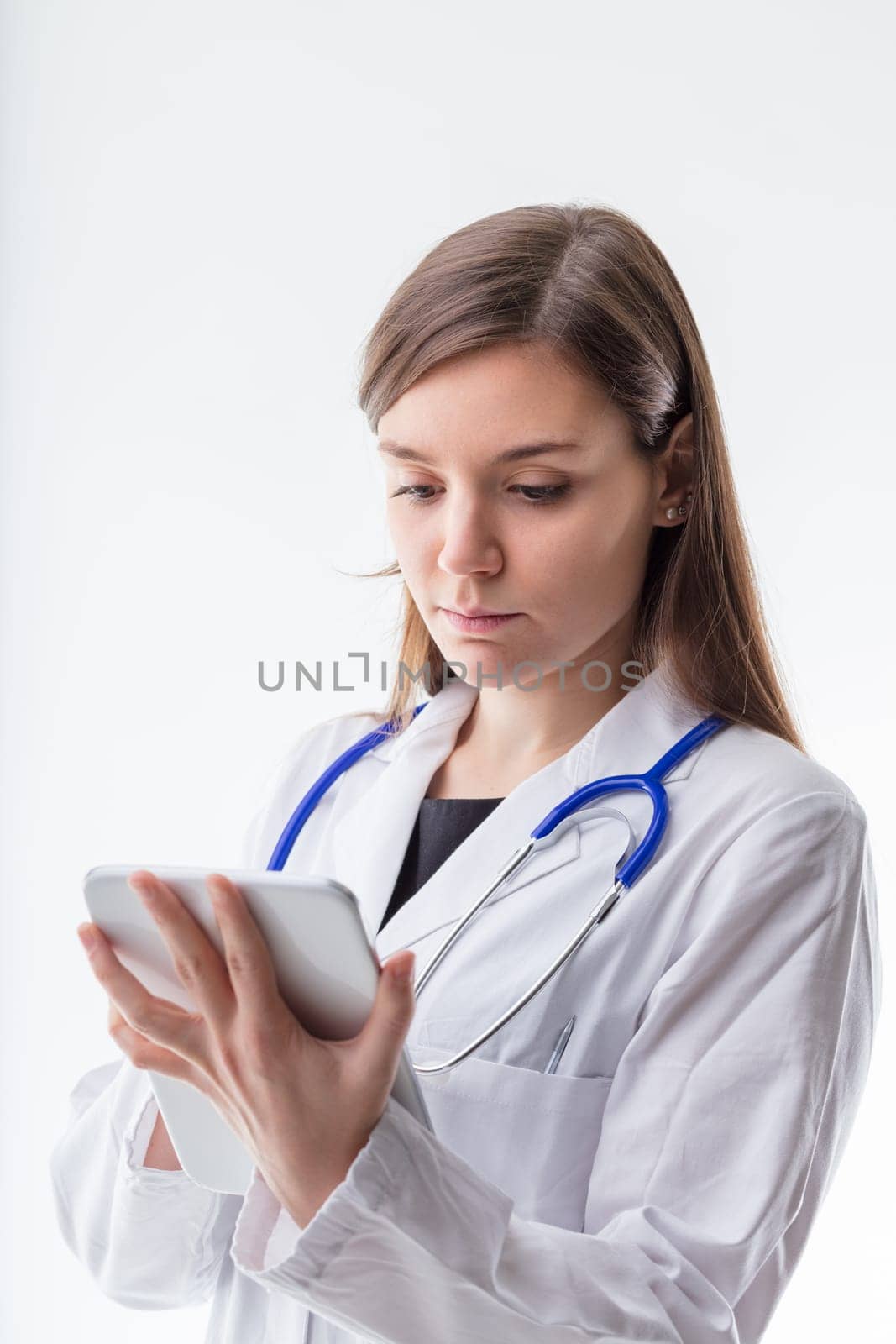 Dedicated healthcare worker meticulously checks medical records on her device, reflecting the importance of accuracy