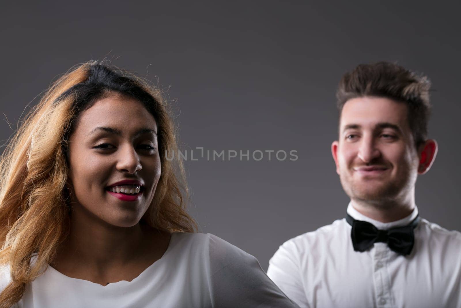 Duo captured in a moment, woman's smile and man's presence complementing