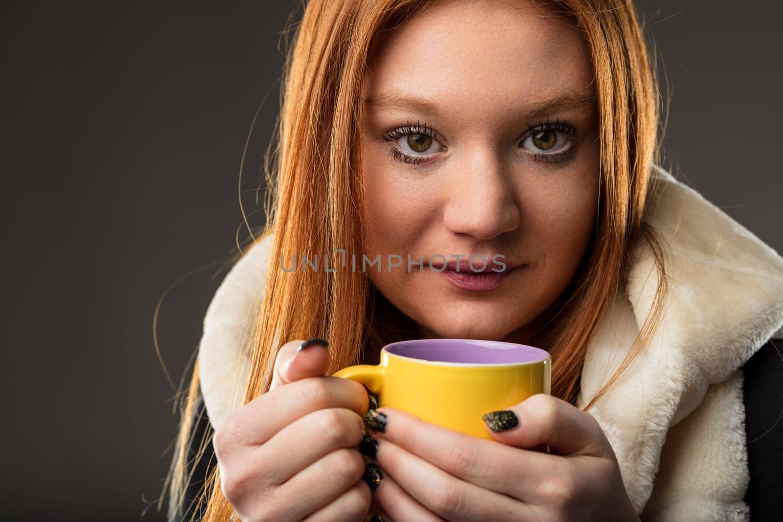 ontemplative redhead with a cup of tea, symbolizing warmth and relaxation