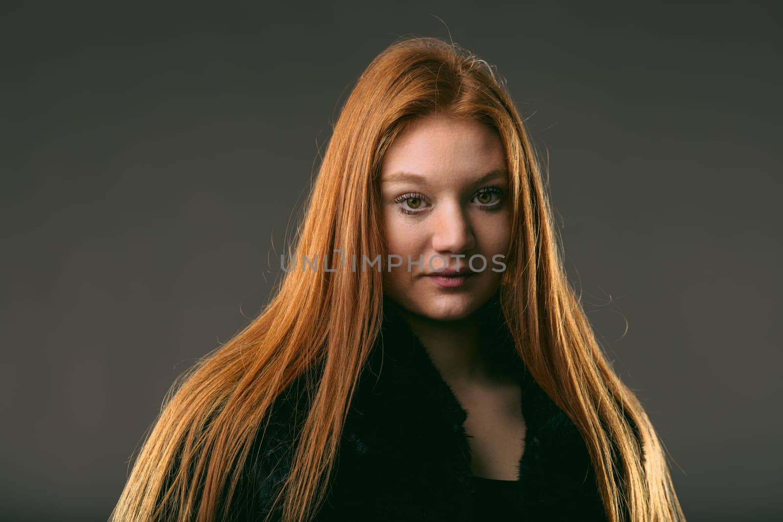 Portrait of a poised young woman with striking auburn hair, exuding confidence and depth