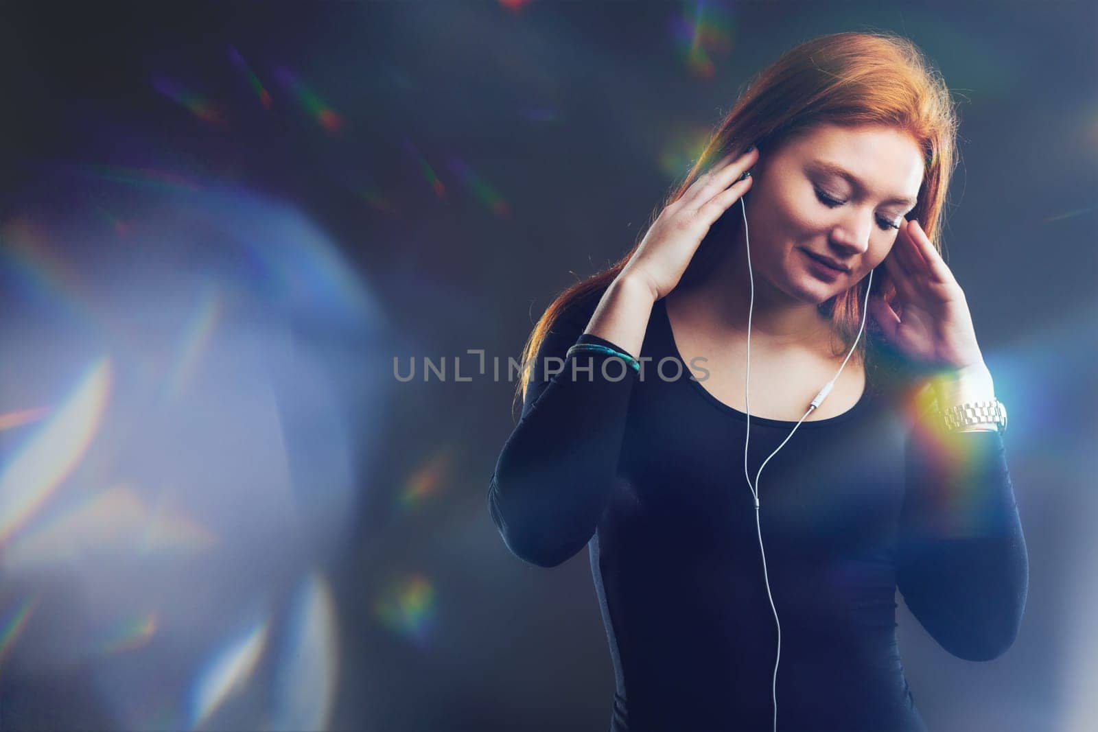 young woman loses herself in the immersive world of music, surrounded by a prism of light reflections