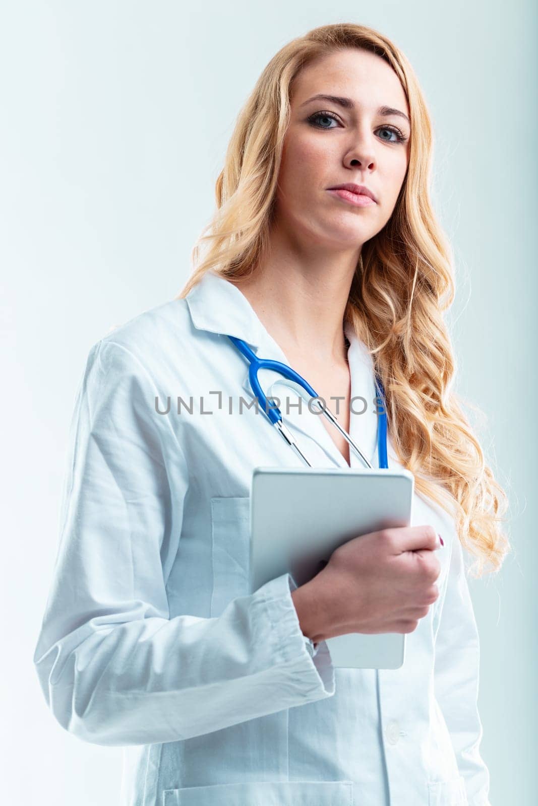 Doctor with digital device in copyspace, useful for telehealth, efficient consultation, patient information handling