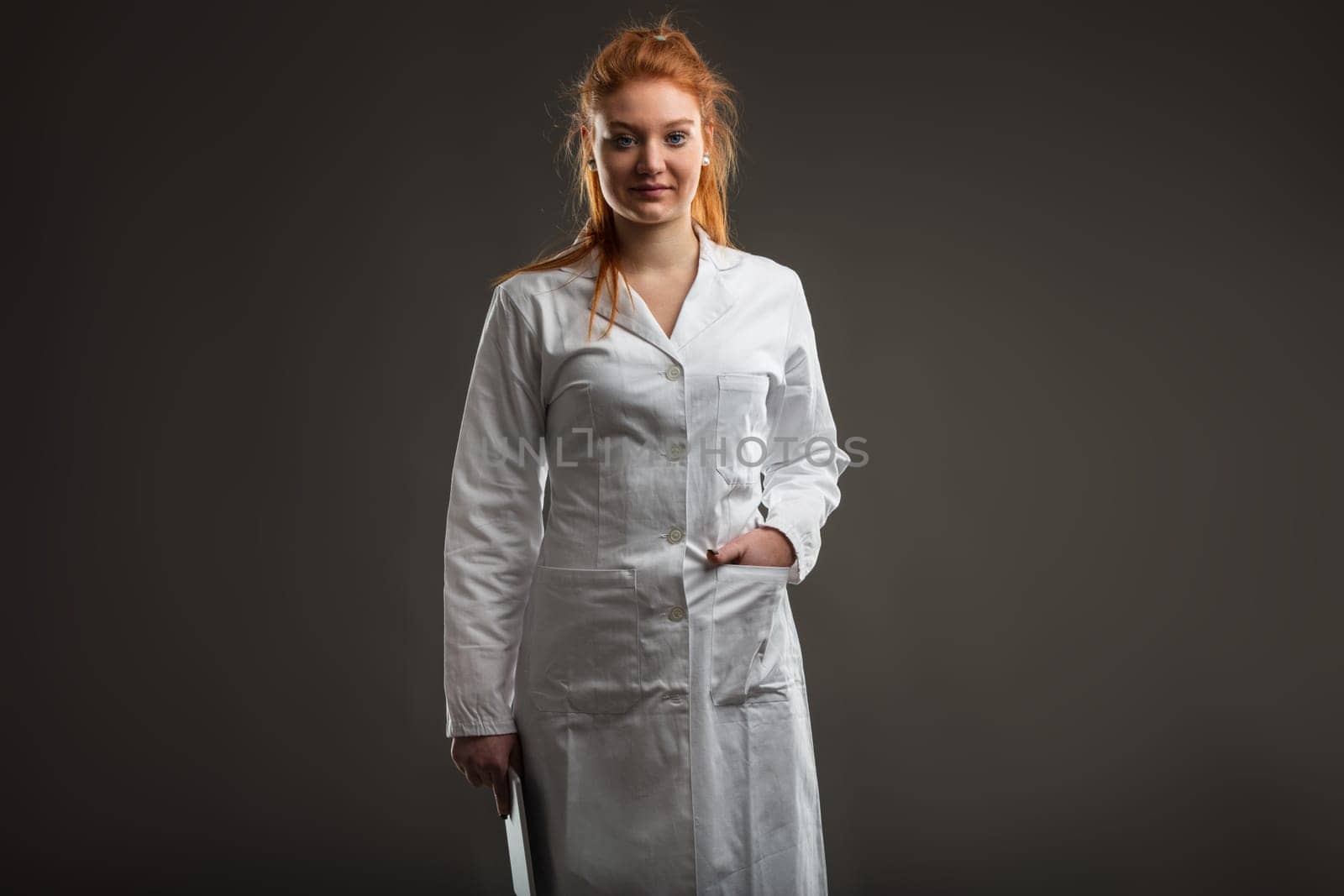 Young medical staff member, her red hair denoting her distinct presence, prepares for a day of digital healthcare