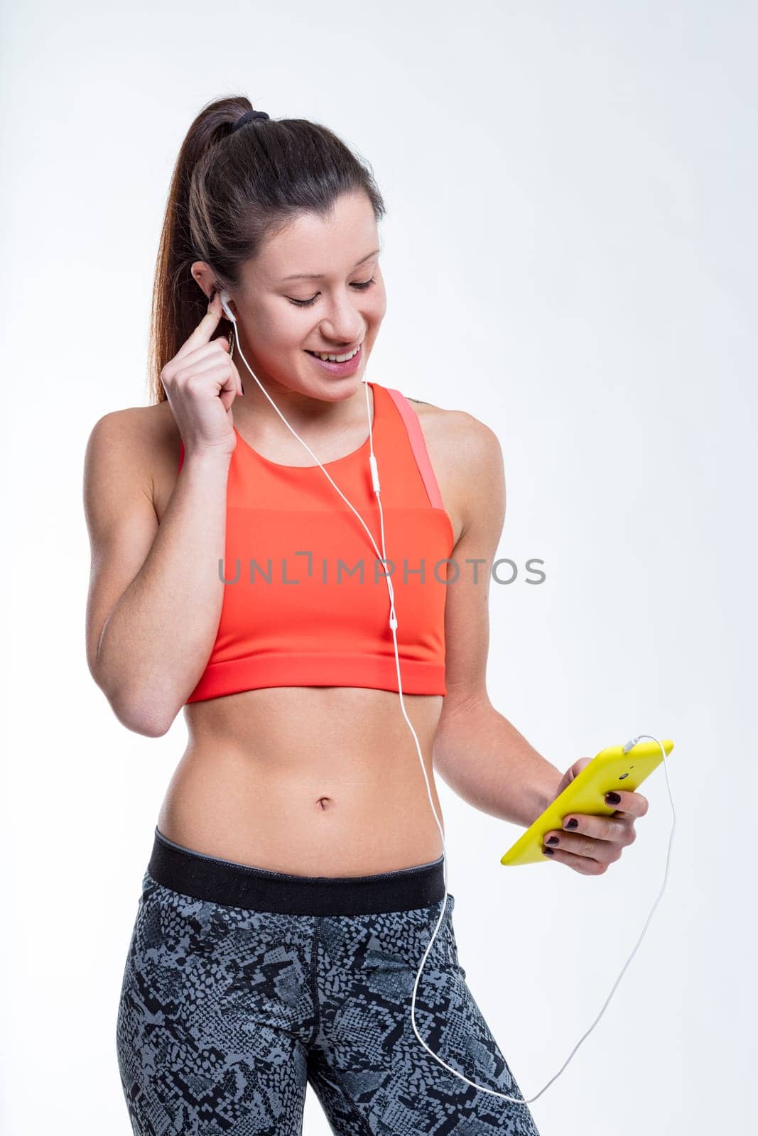 At the gym, an East-Asian woman, in sports clothes, engages with her phone, her smile captures the joy she finds in her fitness journey. Her beautiful boyfriend calls her and then they go out.