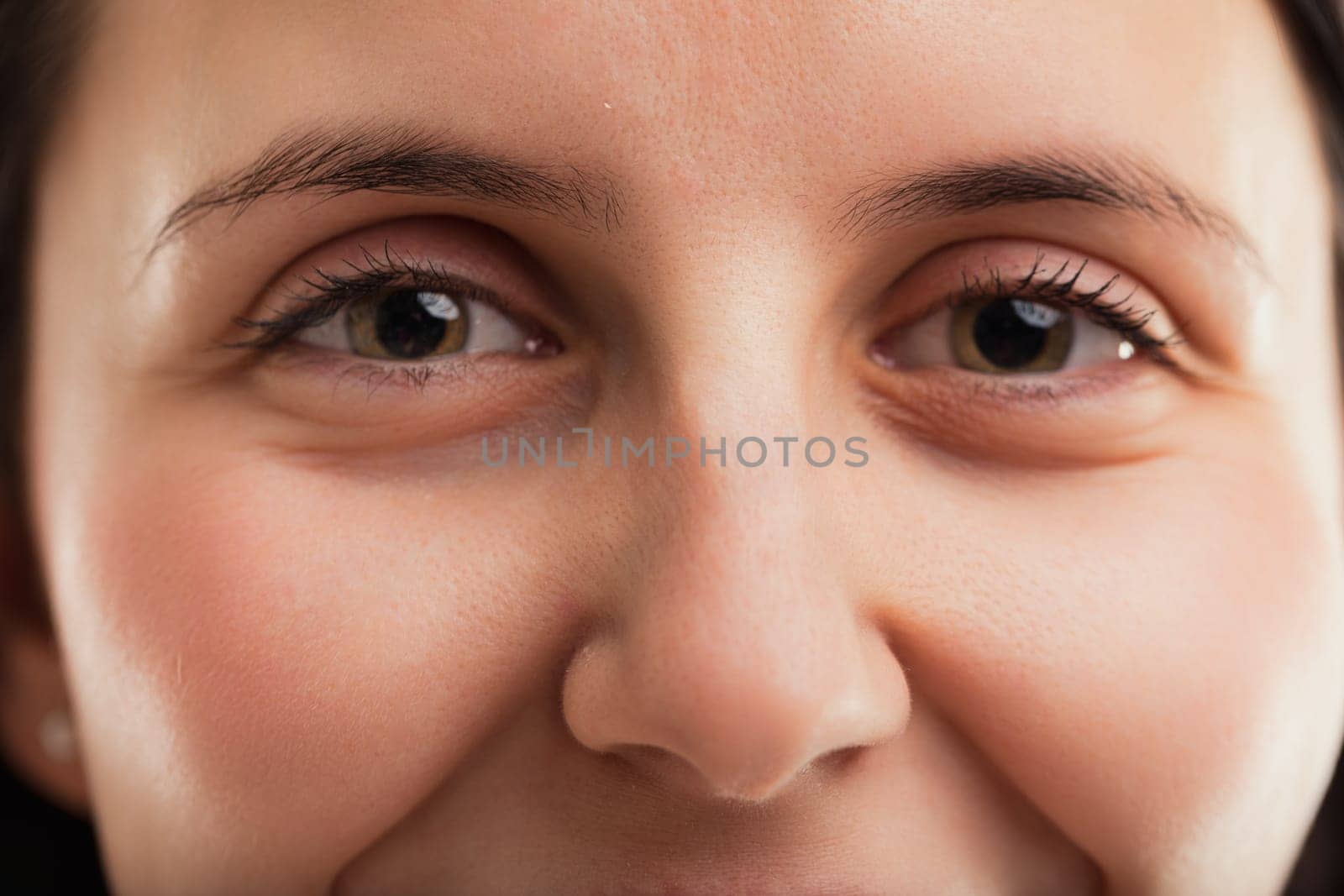 Eyelashes frame the womans eyes, highlighting their depth and the stories they might tell