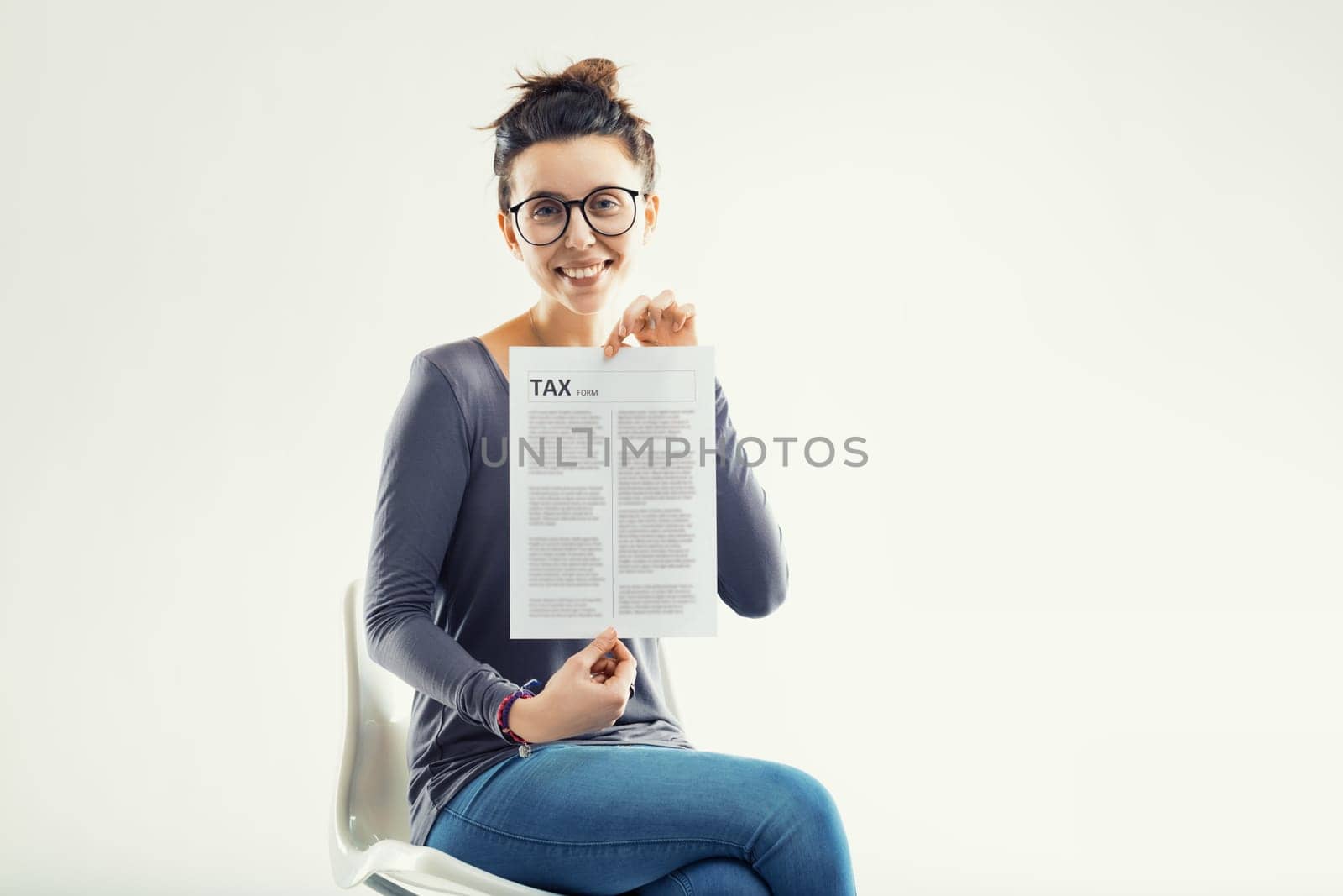 Portraying a positive approach to taxes, she holds the document, dispelling the myth of tax-time anxiety
