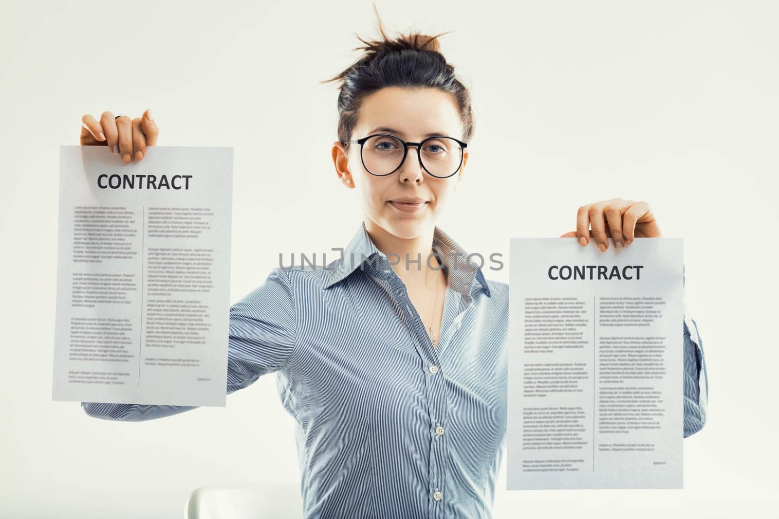 business professional confidently presents two contracts, indicating a successful negotiation or partnership