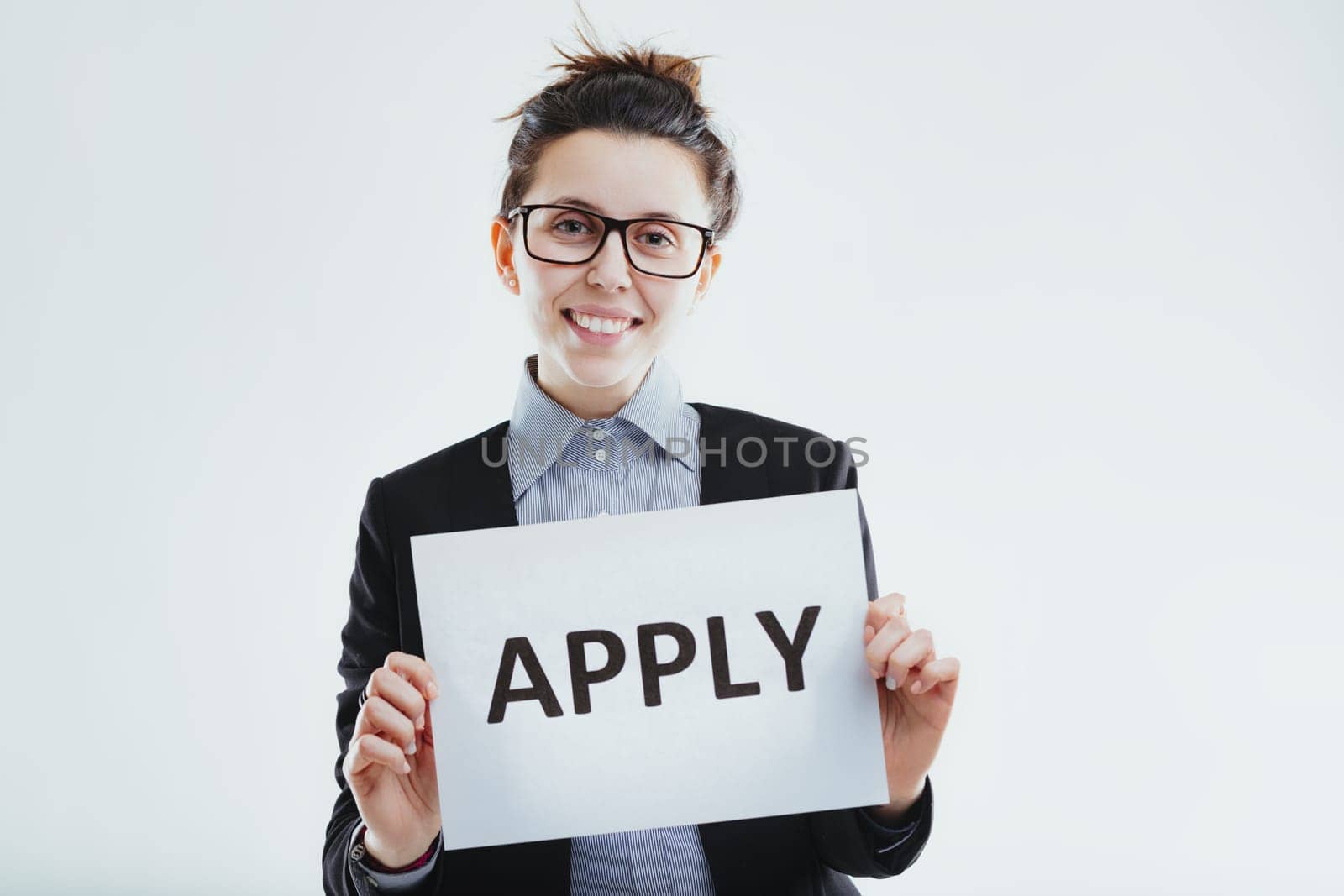 enthusiastic woman communicates an open invitation to apply, suggesting opportunities for career advancement