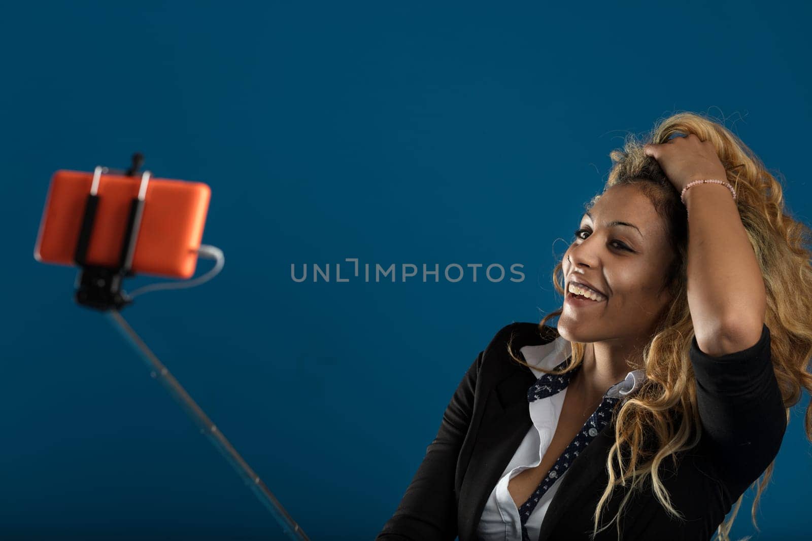 Her curly hair and piercing gaze give a snapshot of modern professionalism blended with fun