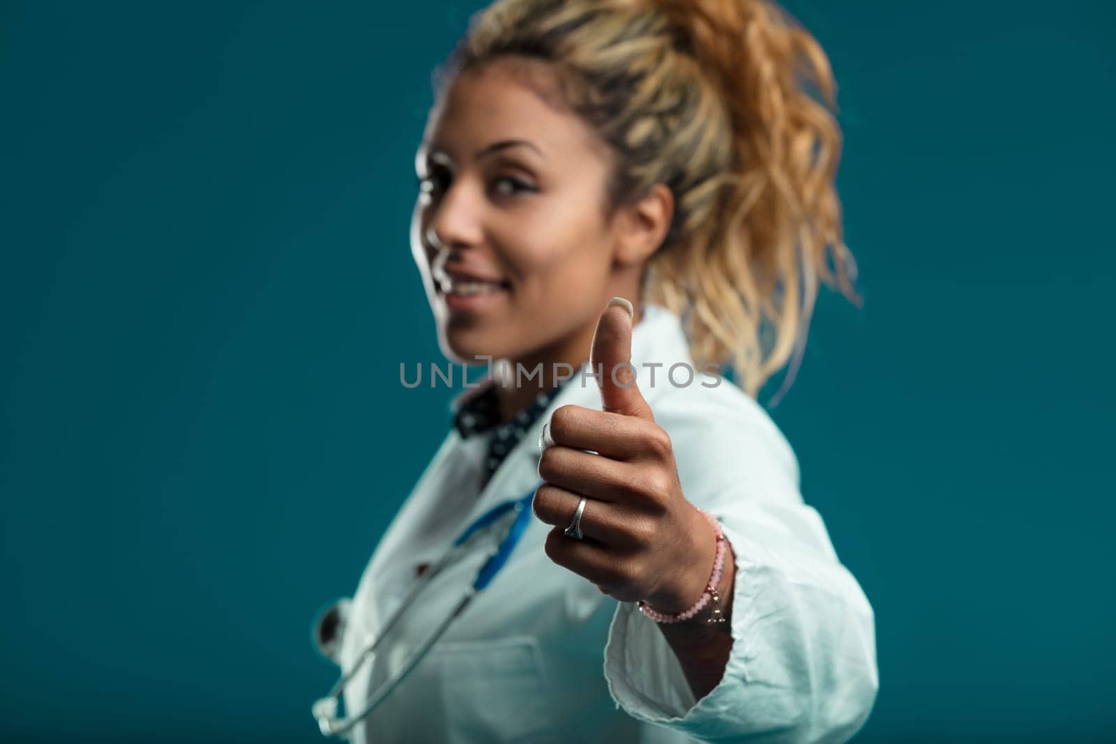 Her confident thumbs-up offers assurance and comfort in her ability to provide quality care