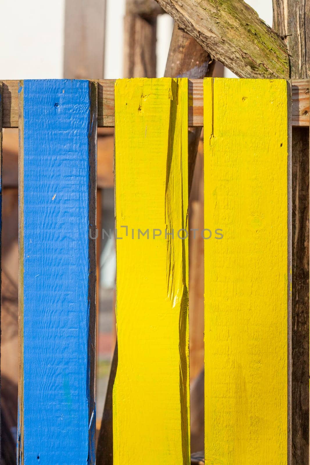 Blue and yellow wooden board fence, Germany