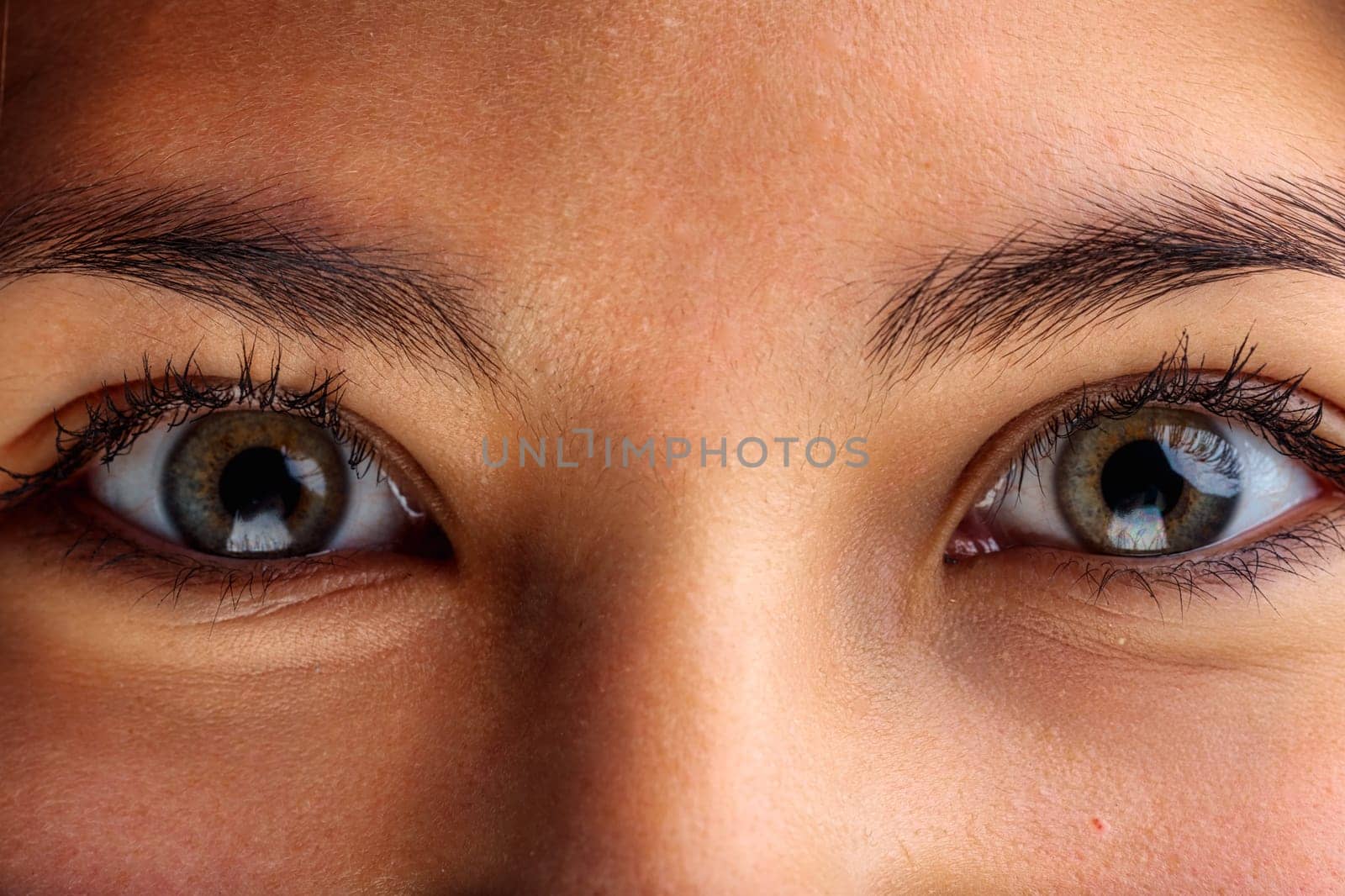 woman's gaze is intense, the intricate details of the iris displayed in high definition