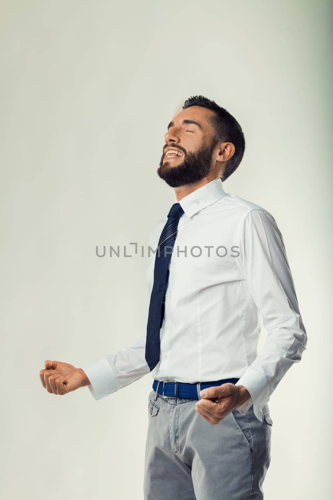 Feeling of victory and relaxation captured as businessman unwinds from tension