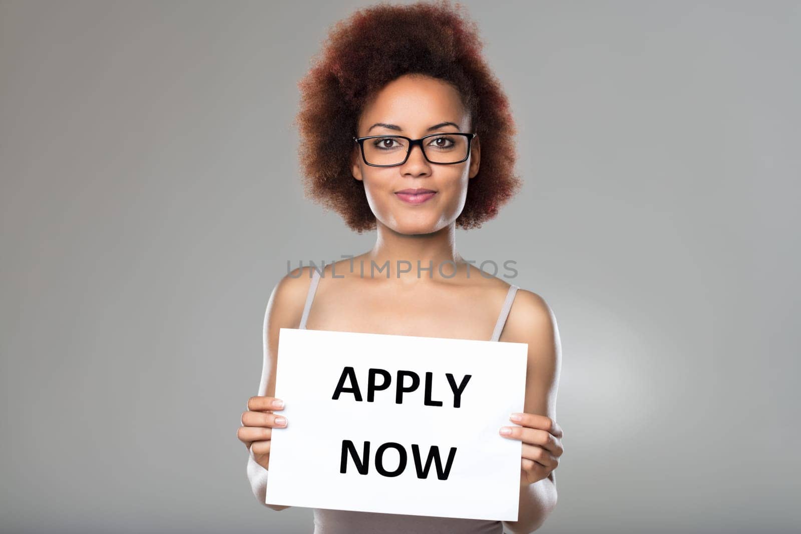 The sign she proudly displays signals a growing team and new professional horizons