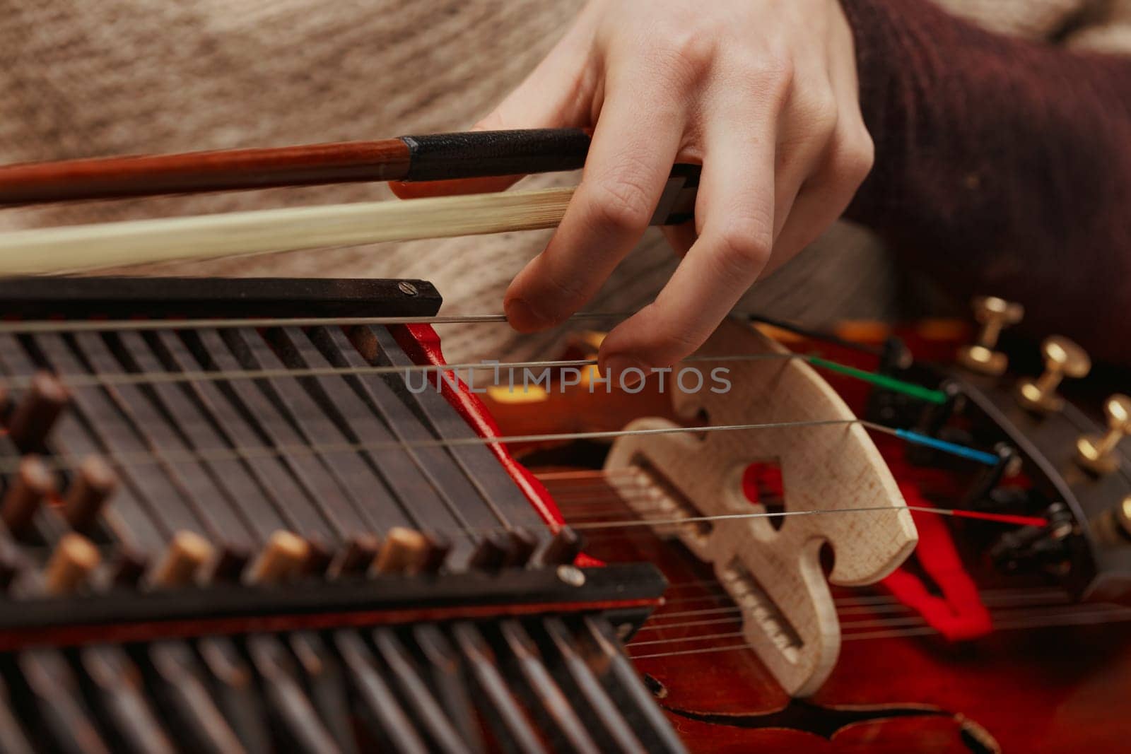 Nyckelharpa, with its resonant strings and unique keys, held by a performer deeply connected to heritage music