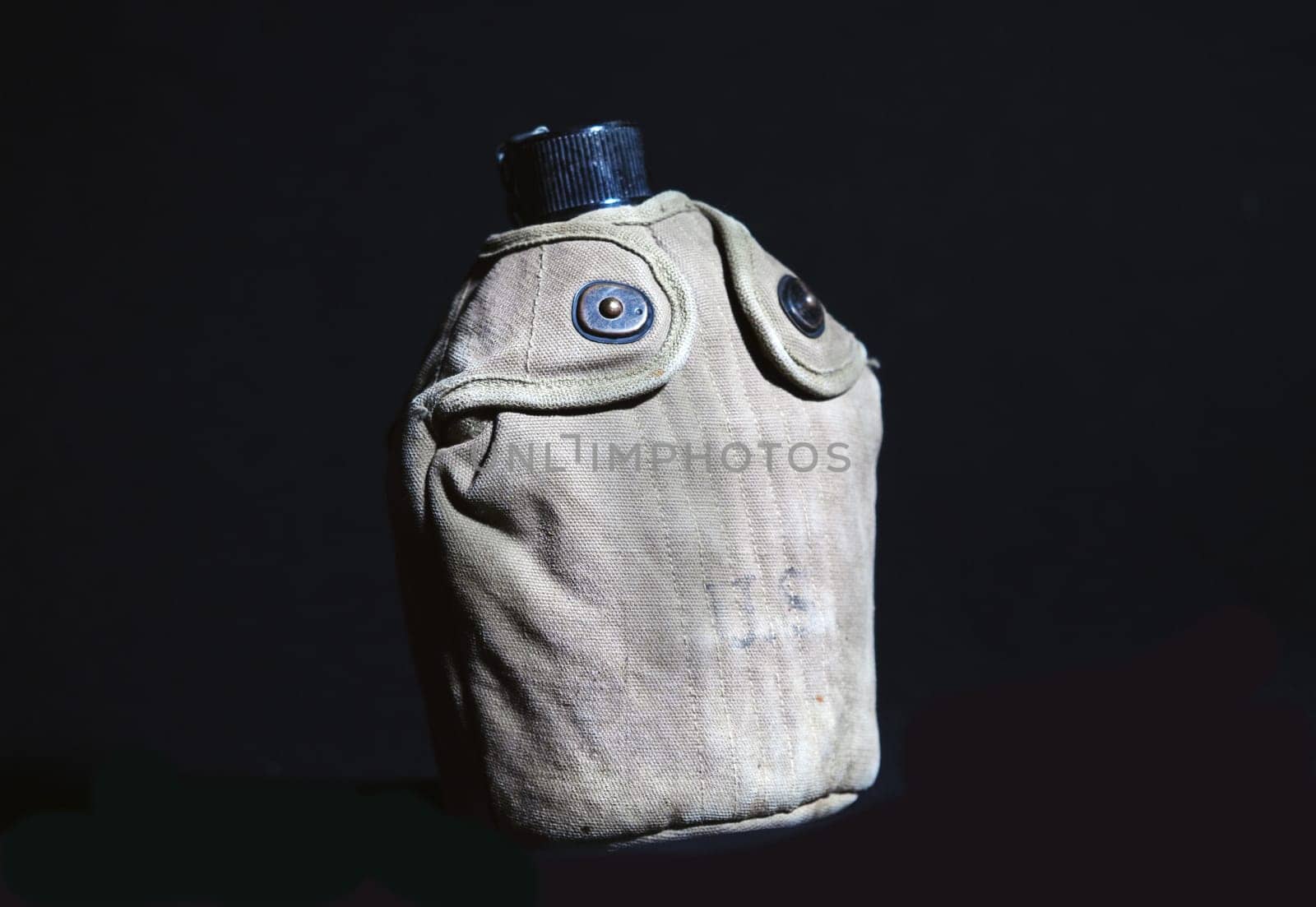 a ww2 military us canteen on black background