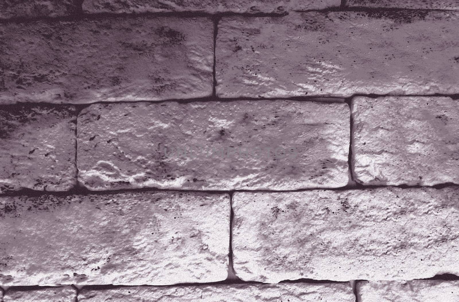 An old monochrome wall of blocks in close-up