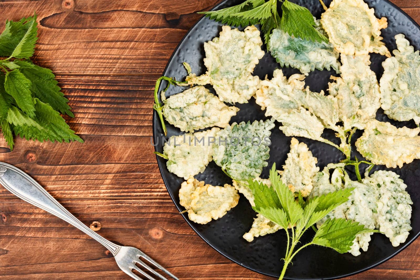 Breaded nettle leaves or battered nettle. Hot spring greens appetizer. Copy space.