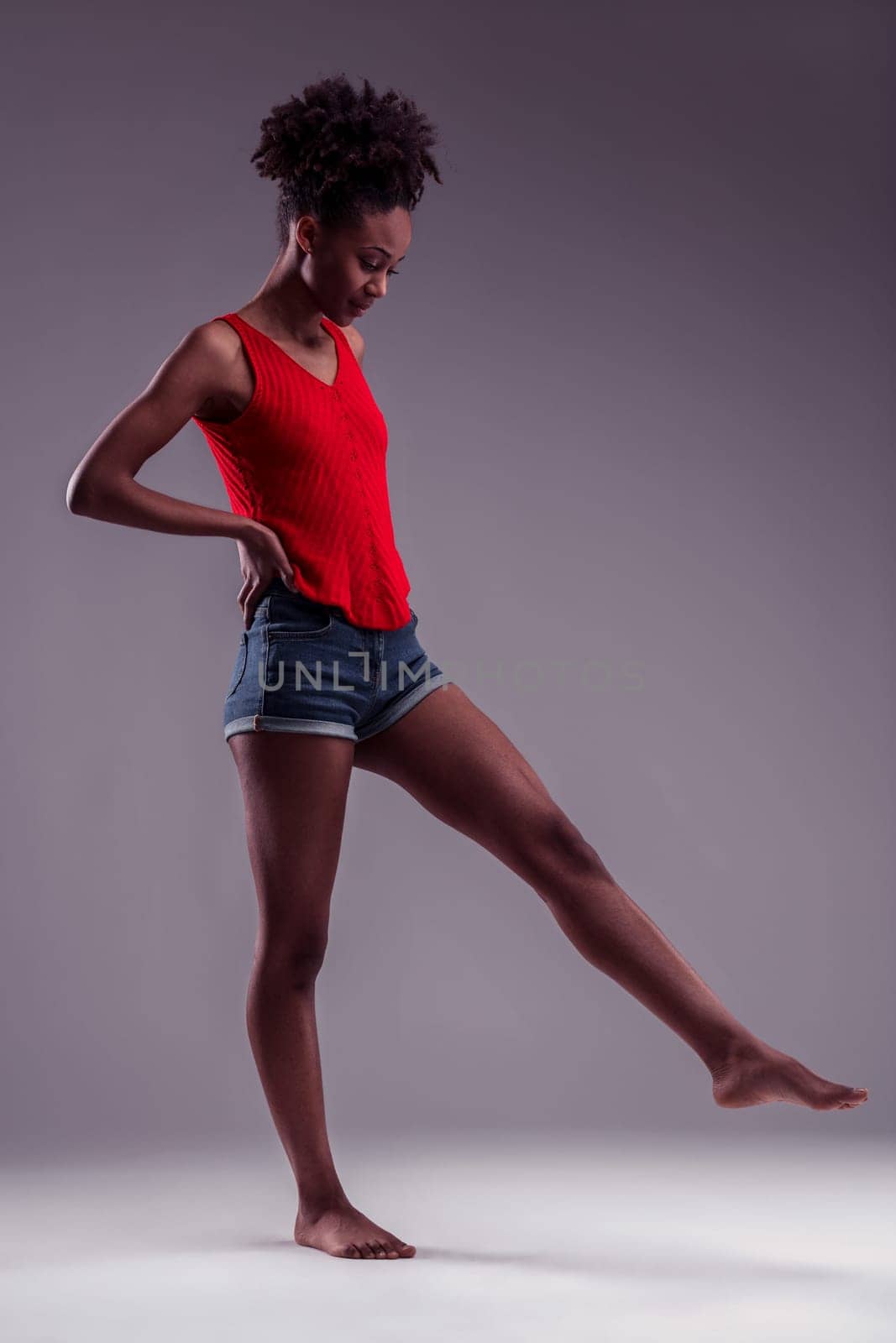 Lifting her leg high, she combines style and athleticism in a casual setting