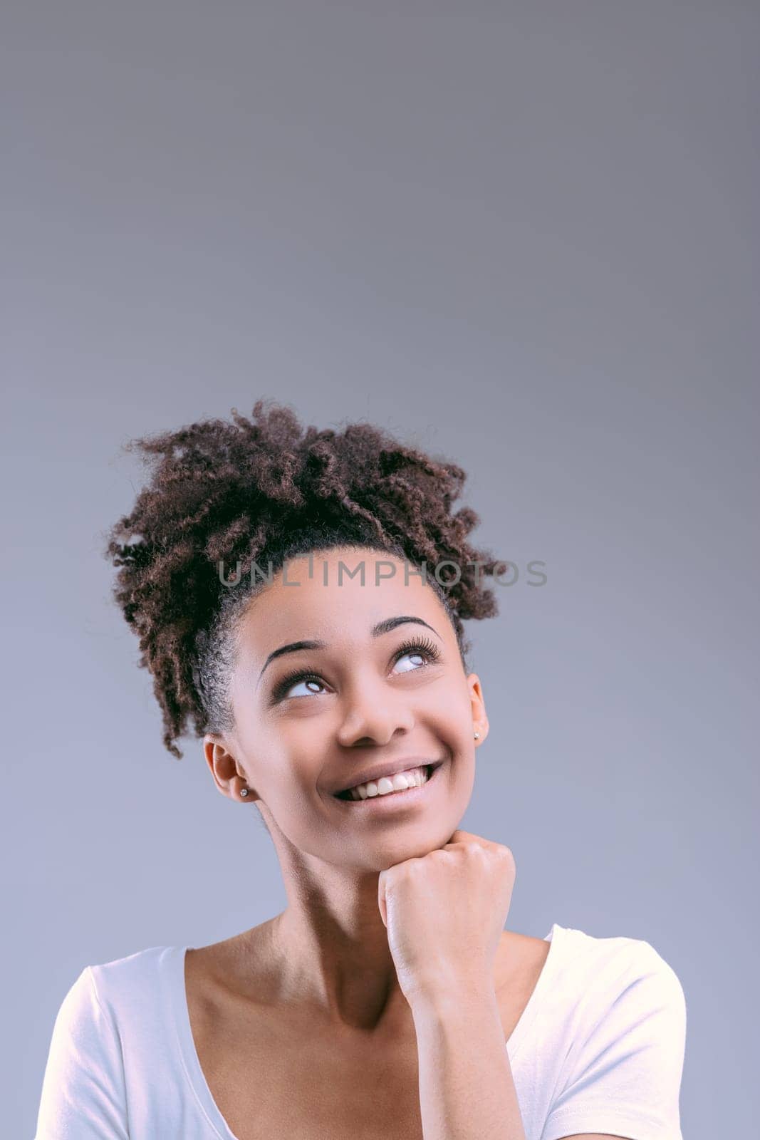 Black woman in a white shirt points up, suggesting a thought has struck