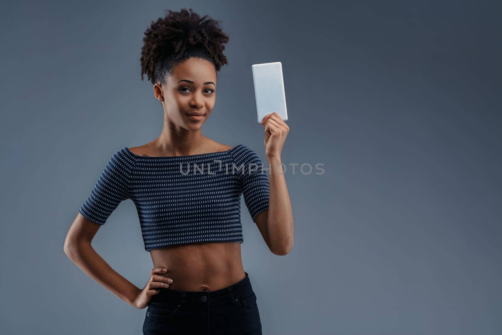 Tech-savvy female recommends app solutions, smartphone in hand, looking assured