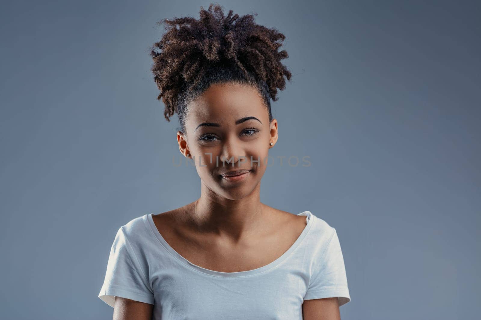 Energetic young woman's laughter lights up her natural look
