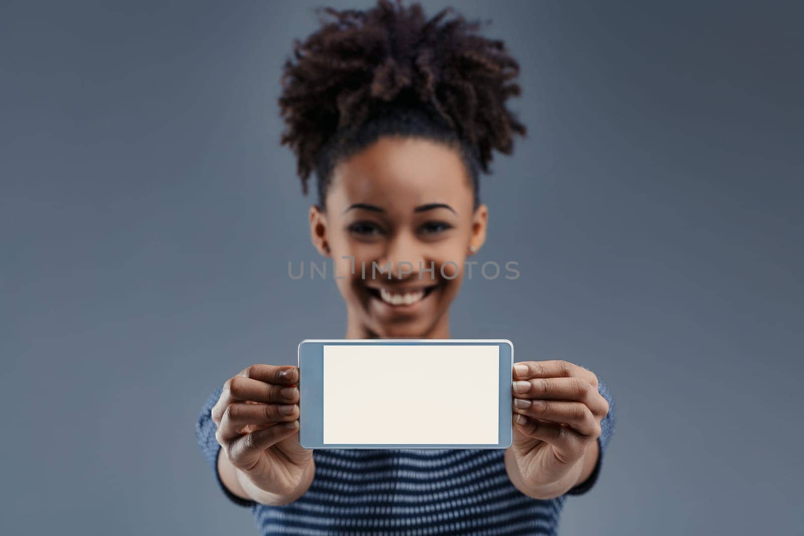 Enthusiastically holding a smartphone, the woman's cheerful demeanor suggests endless possibilities in technology