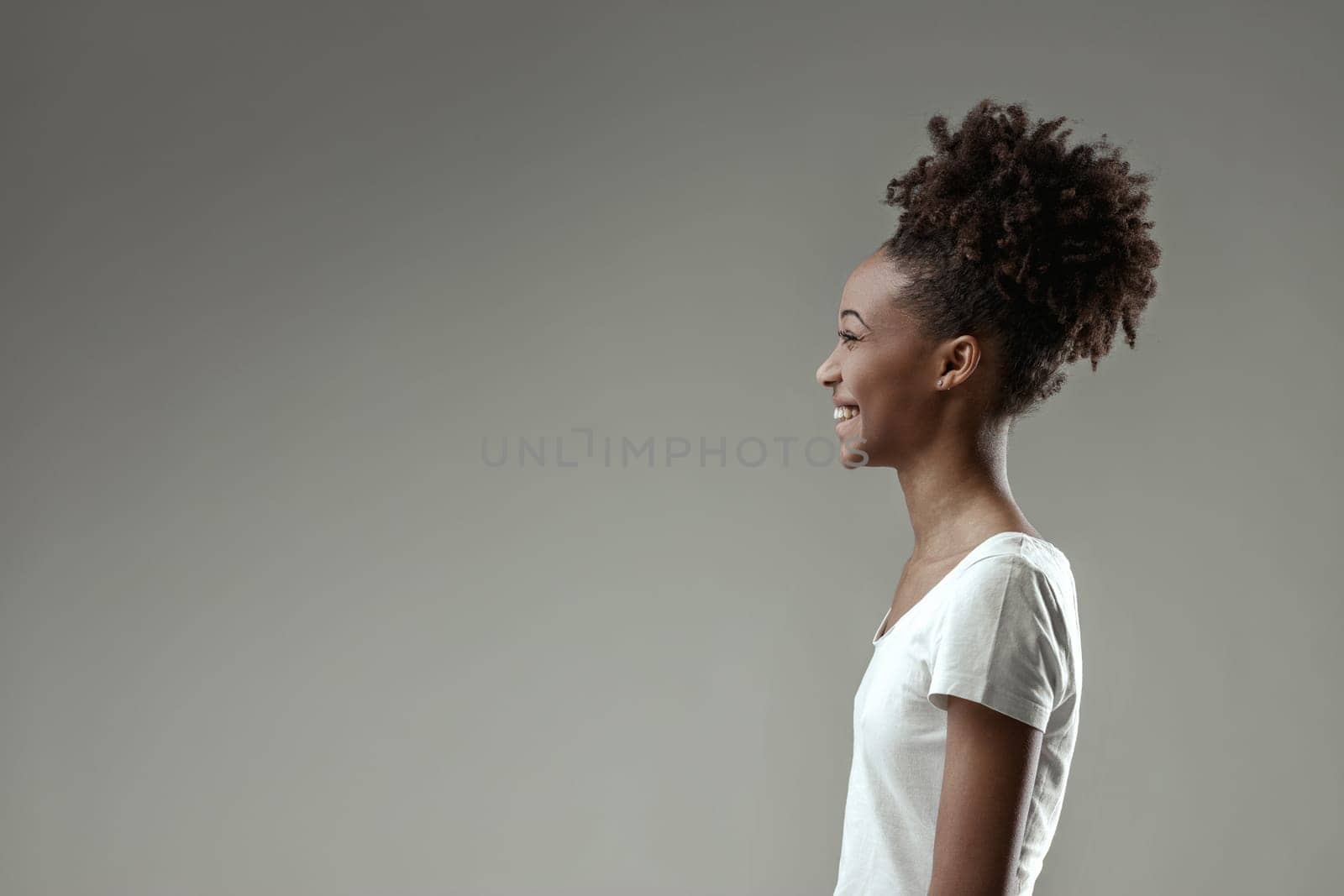 young woman's face radiates happiness as she reacts to a delightful moment, her joy unmistakable