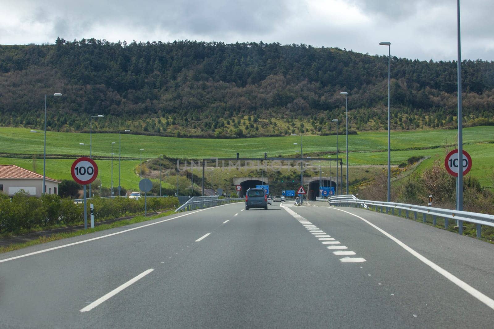 Driving along A-12 highway. Vehicules getting close to Erreniega Tunnel at Sierra del Perdon, Navarre, Spain