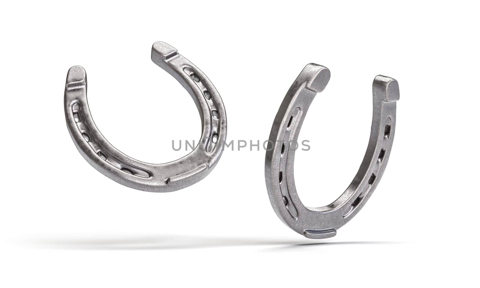 Two shiny metal horseshoes facing each other isolated on a white backdrop