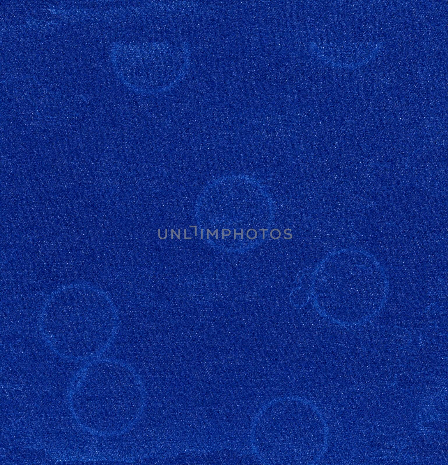 A blue abstract close-up structure with a circular pattern and streaks on the surface