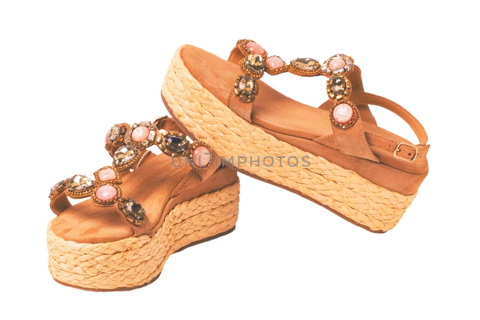 Leather shoes isolated. Close-up of a single of elegant female suede sandals with rhinestones. Isolated on white background. Macro.