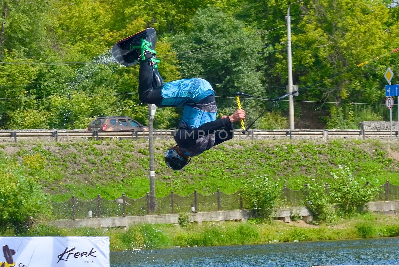 Russia, Volgodonsk - June 18, 2015: Water snowboard. The athlete with snowboard hold on to the rope and the boat accelerates.