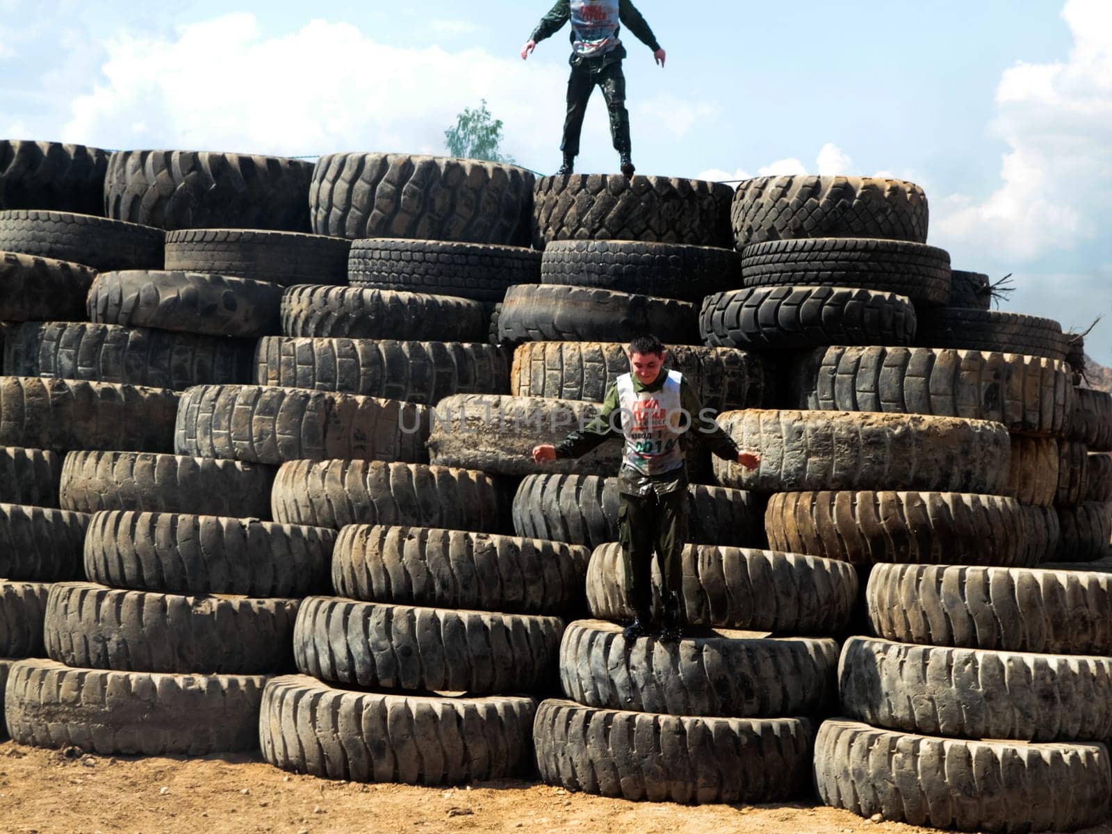 Athletes overcome a bunch of tires.