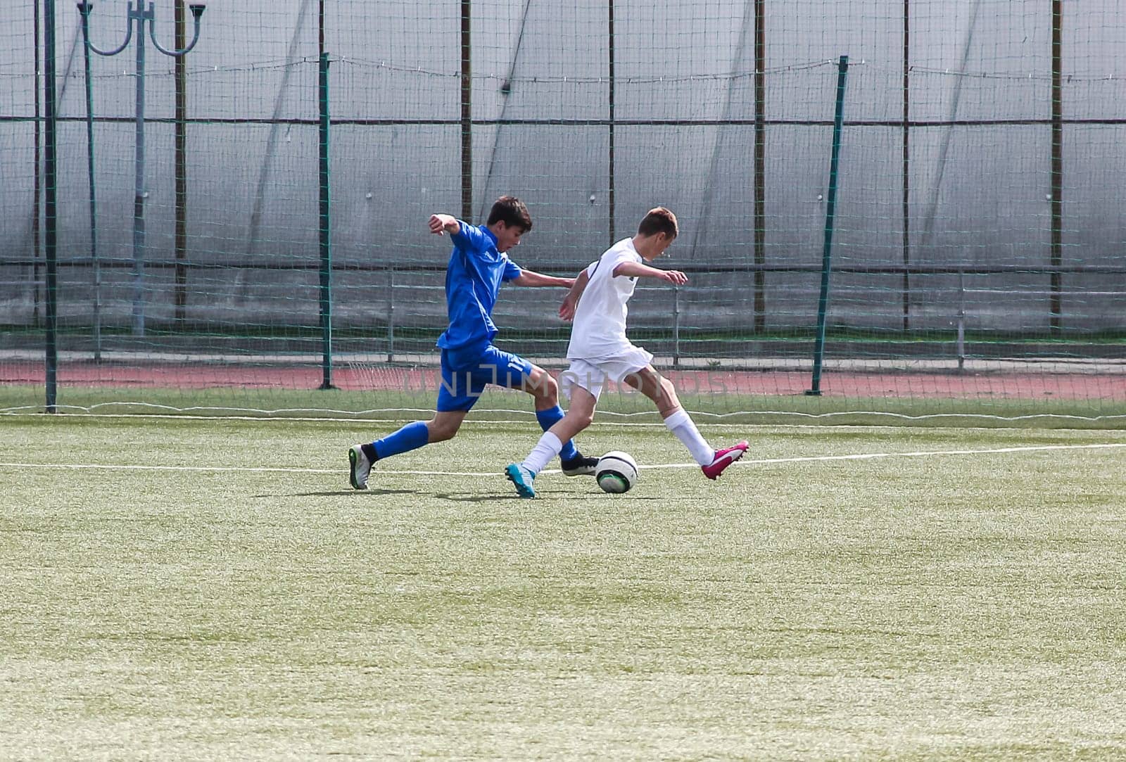 Russia, Volgodonsk - may 17, 2015: Football game. Training matches junior teams and fans