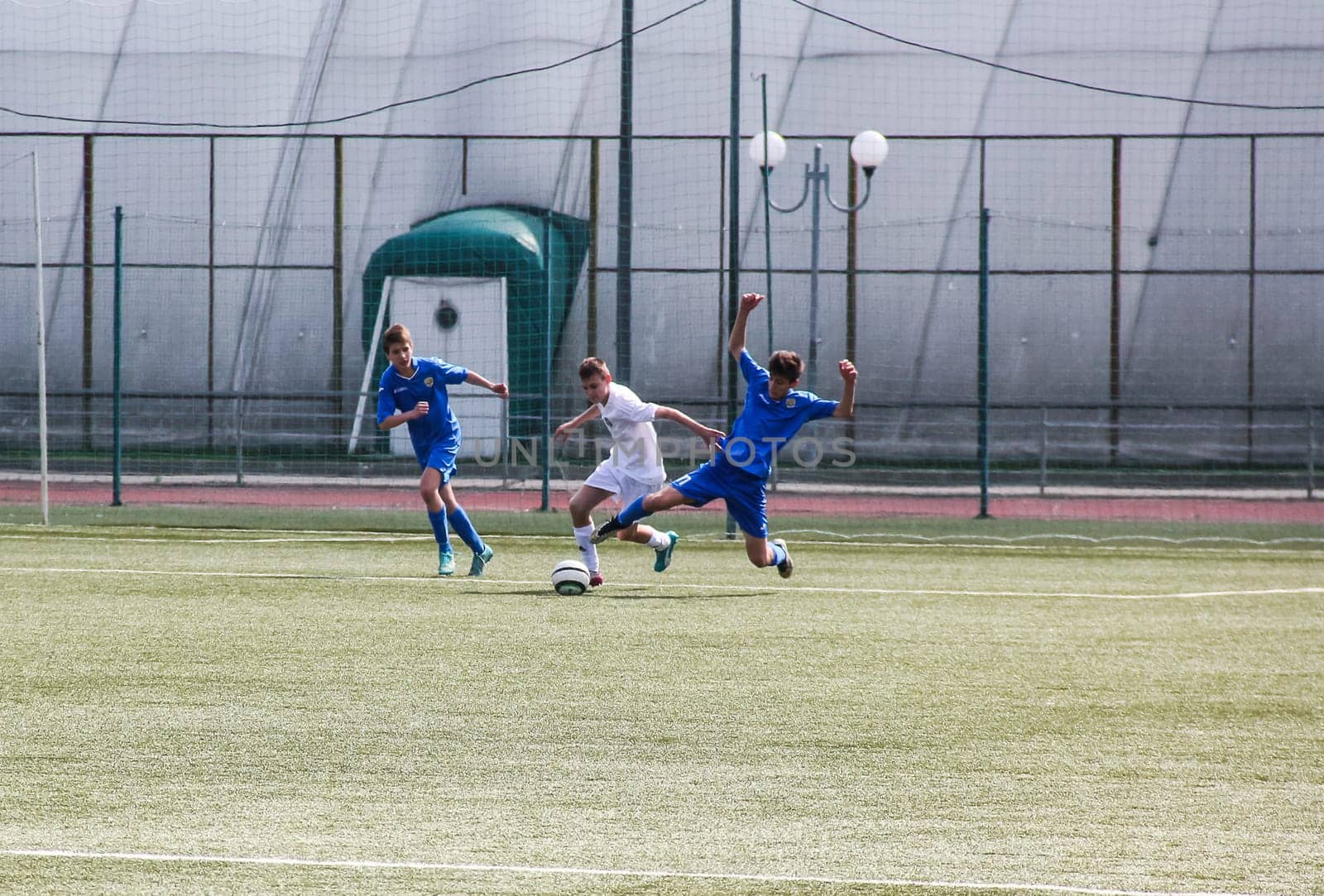 Russia, Volgodonsk - may 17, 2015: Football game. Training matches junior teams and fans
