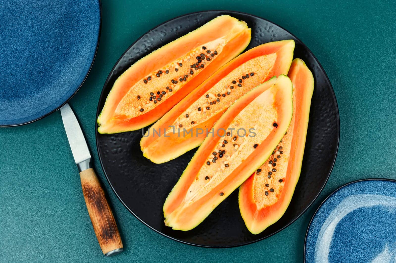 Sliced fresh juicy papaya on the table. Papaya exotic fruits. Top view.