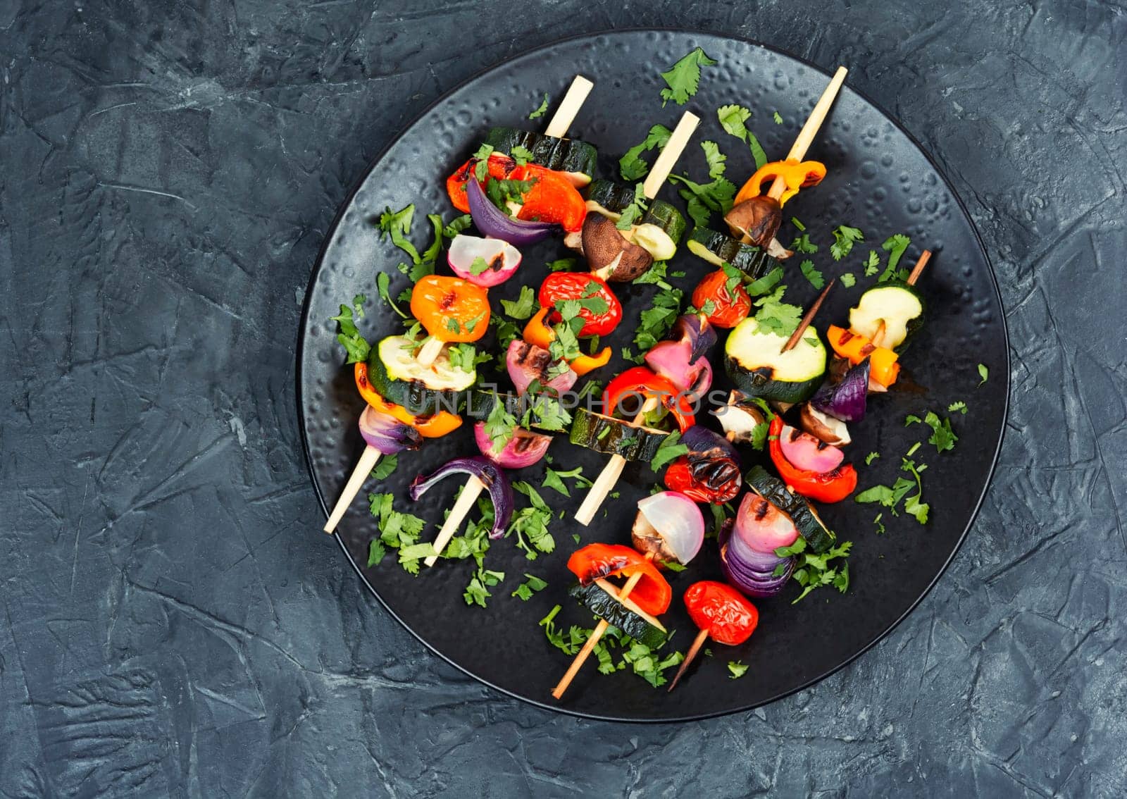 Vegetable juicy skewers, grilled vegetables or barbecue vegetables on wooden skewers. Summer barbecue food.