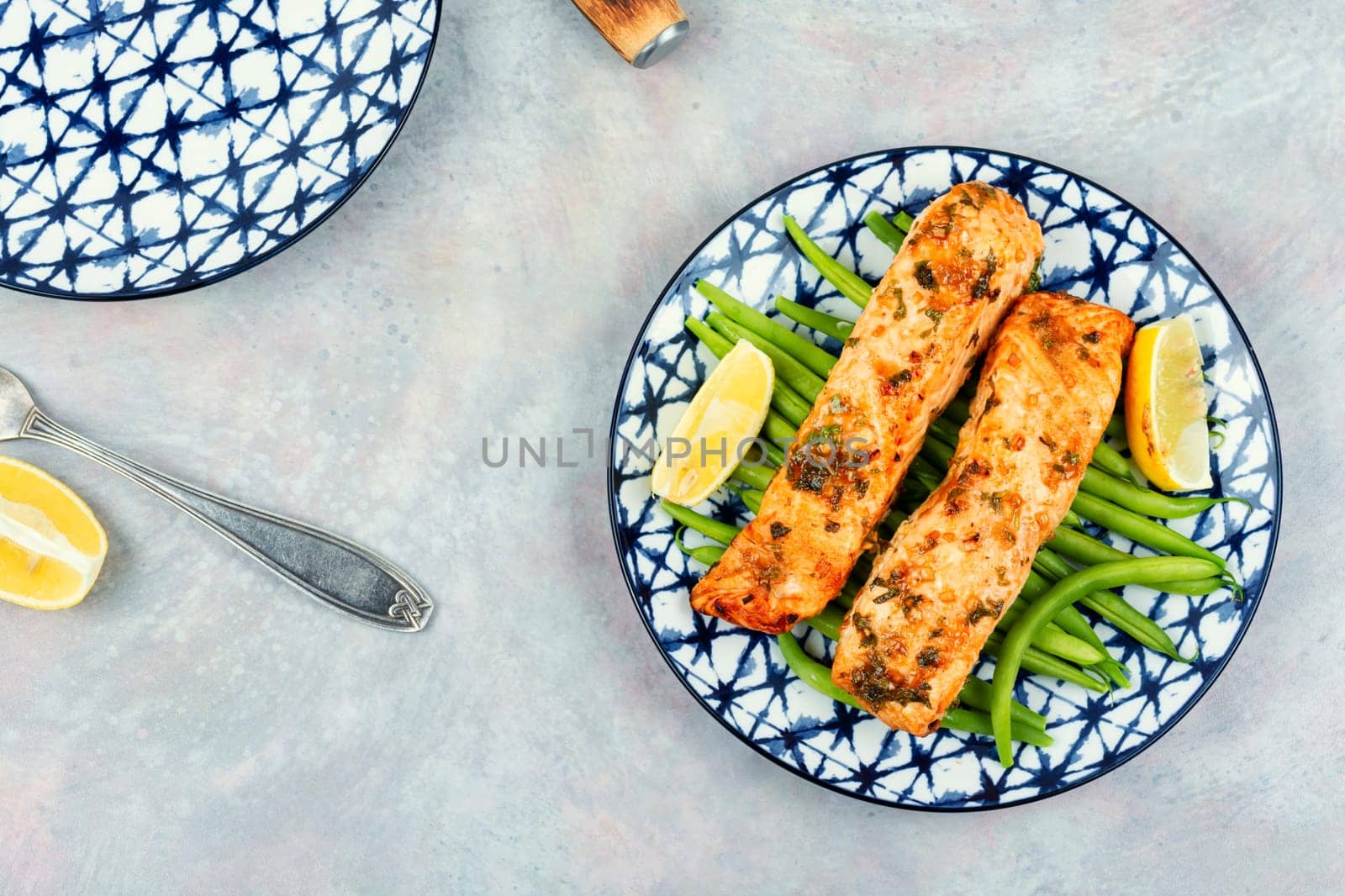 Tasty roasted salmon fish with bush green beans on the plate. Paleo, keto diet. Space for text.