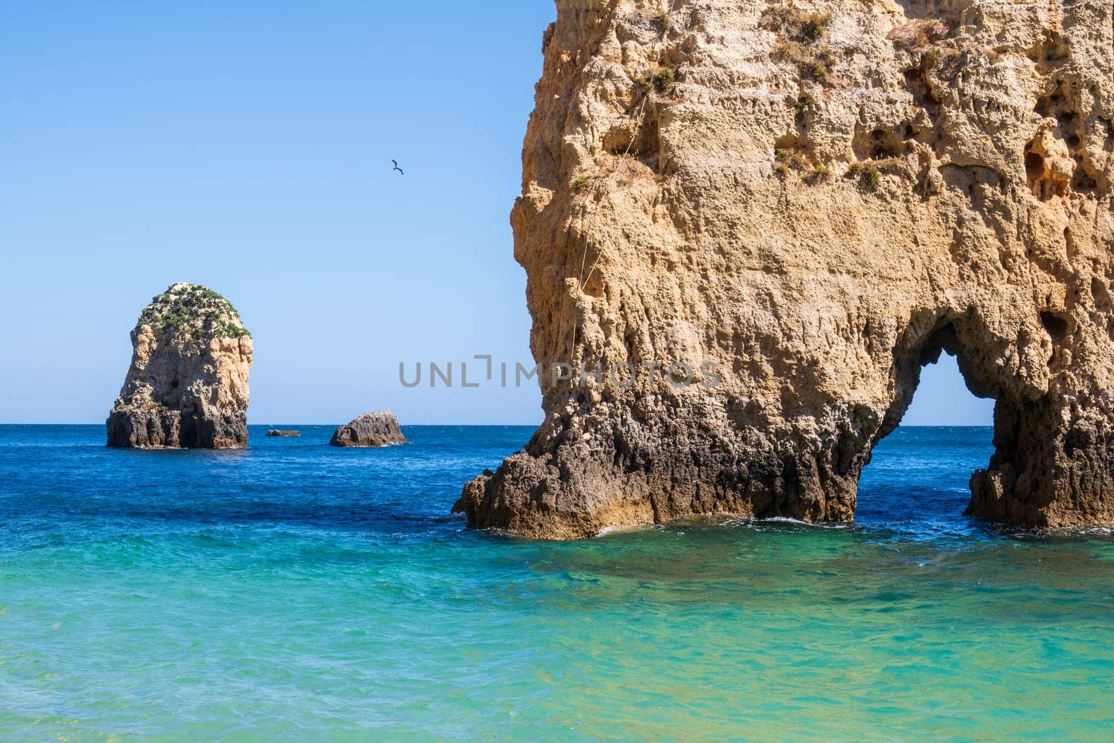 Balanced complementary symmetry of rocks at a heavenly beach photographed near Portimão, Algarve, Portugal
