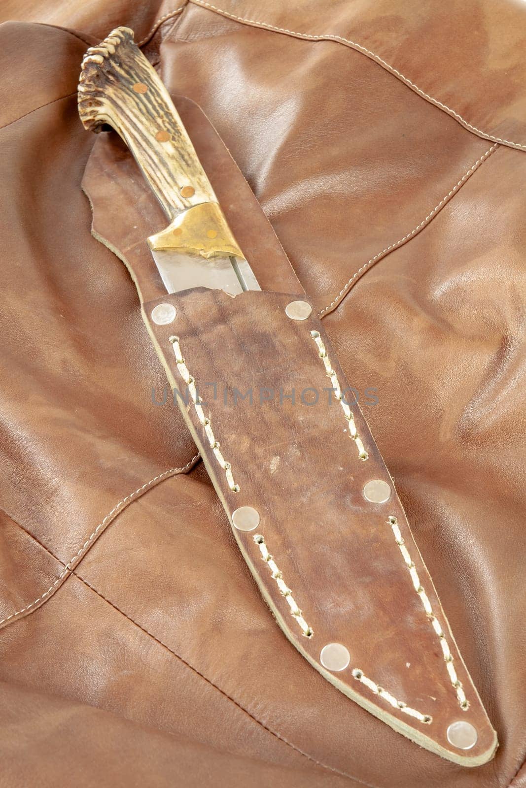 Hunting knife with antler handle. Selective focus with shallow depth of field.