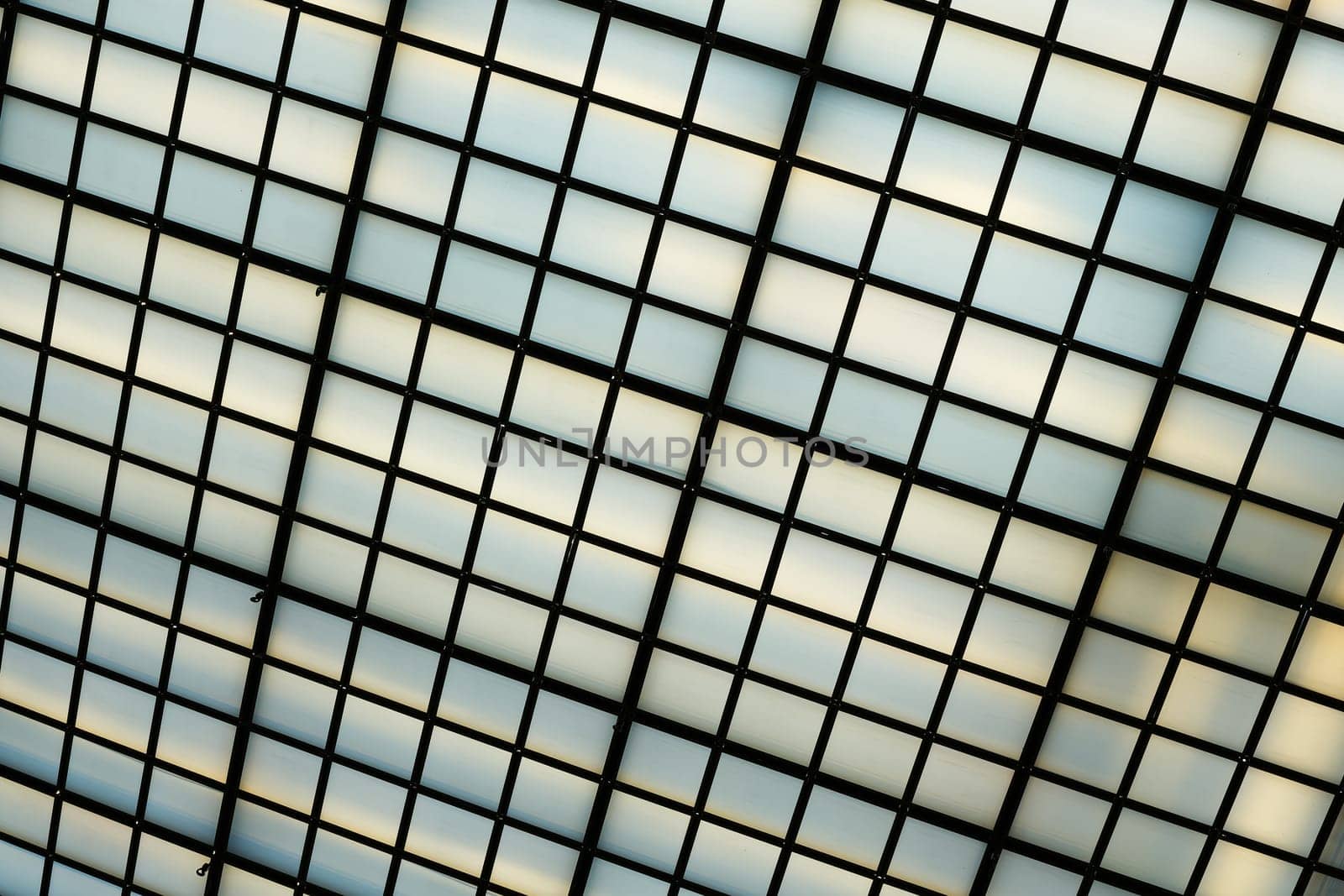 Ceiling construction of an office building with many glass panes to capture daylight