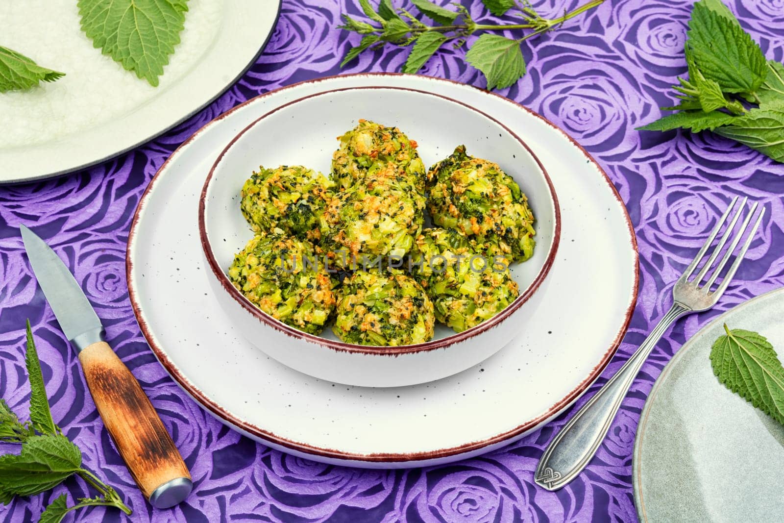 Vegetarian cutlets of cutlet nettles leaves and broccoli. Fried nettle meat balls on wooden rustic table