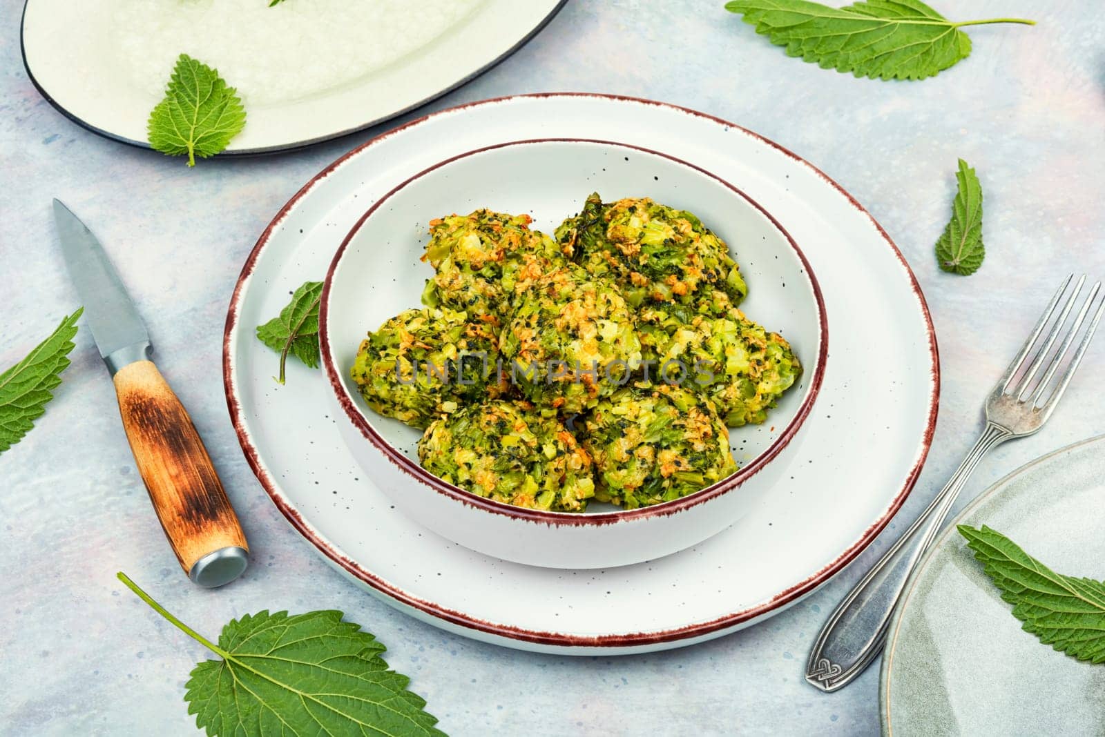 Vegetarian cutlets of cutlet nettles leaves and broccoli. Fried nettle meat balls on wooden rustic table
