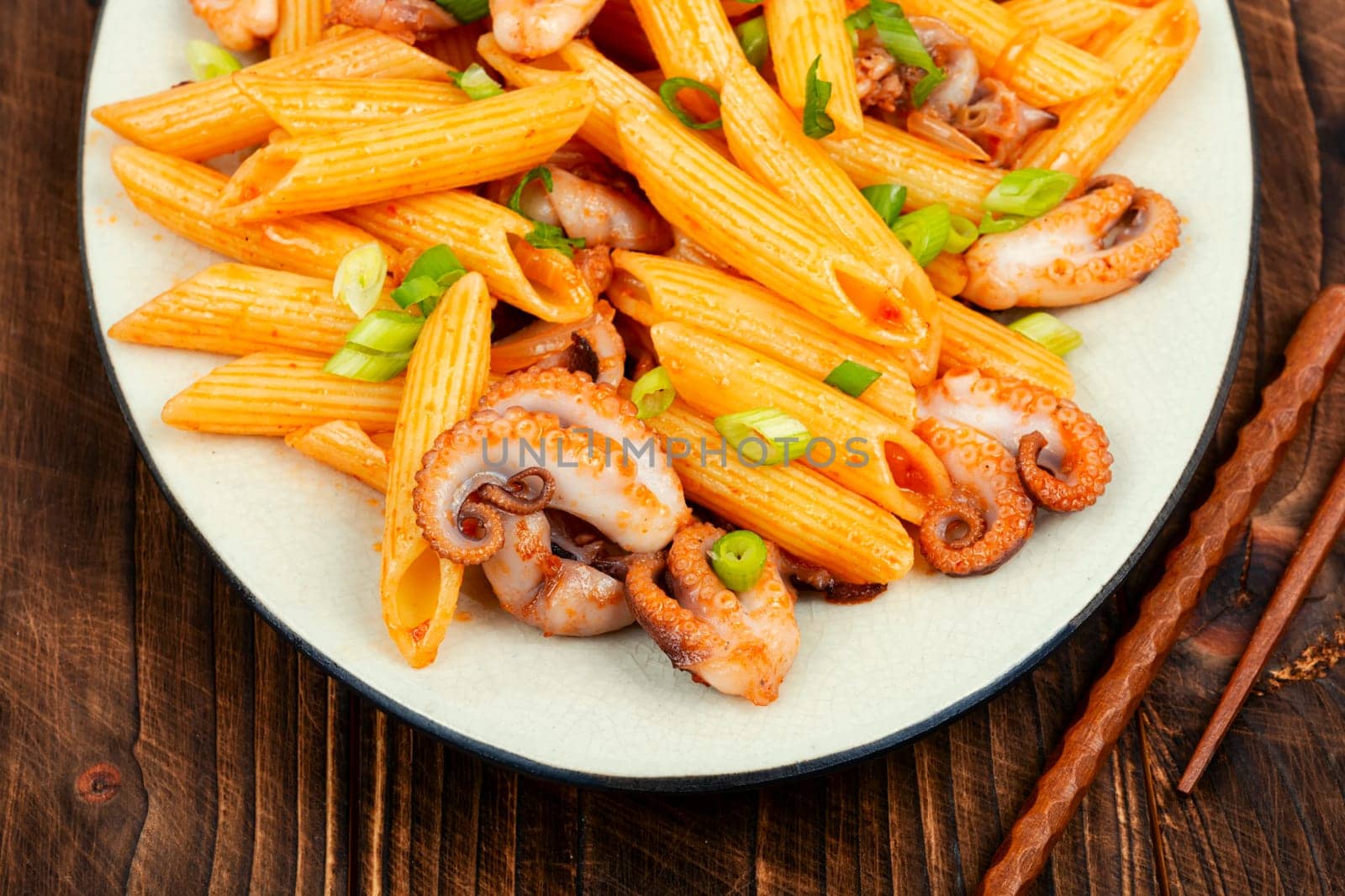Delicious macaroni or pasta with octopus. Macaroni with seafood. American appetizer.