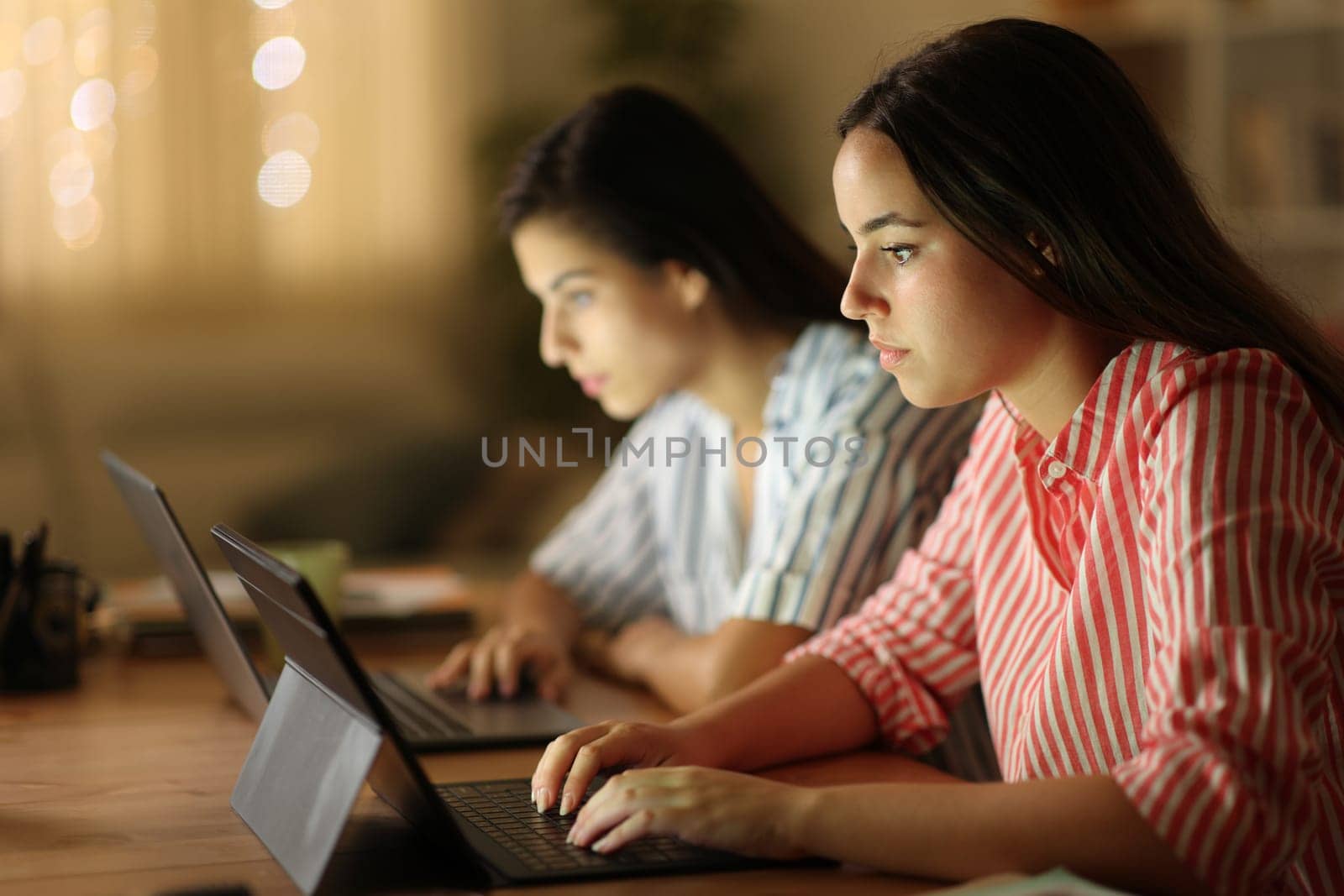 Tele workers working online in the night at home