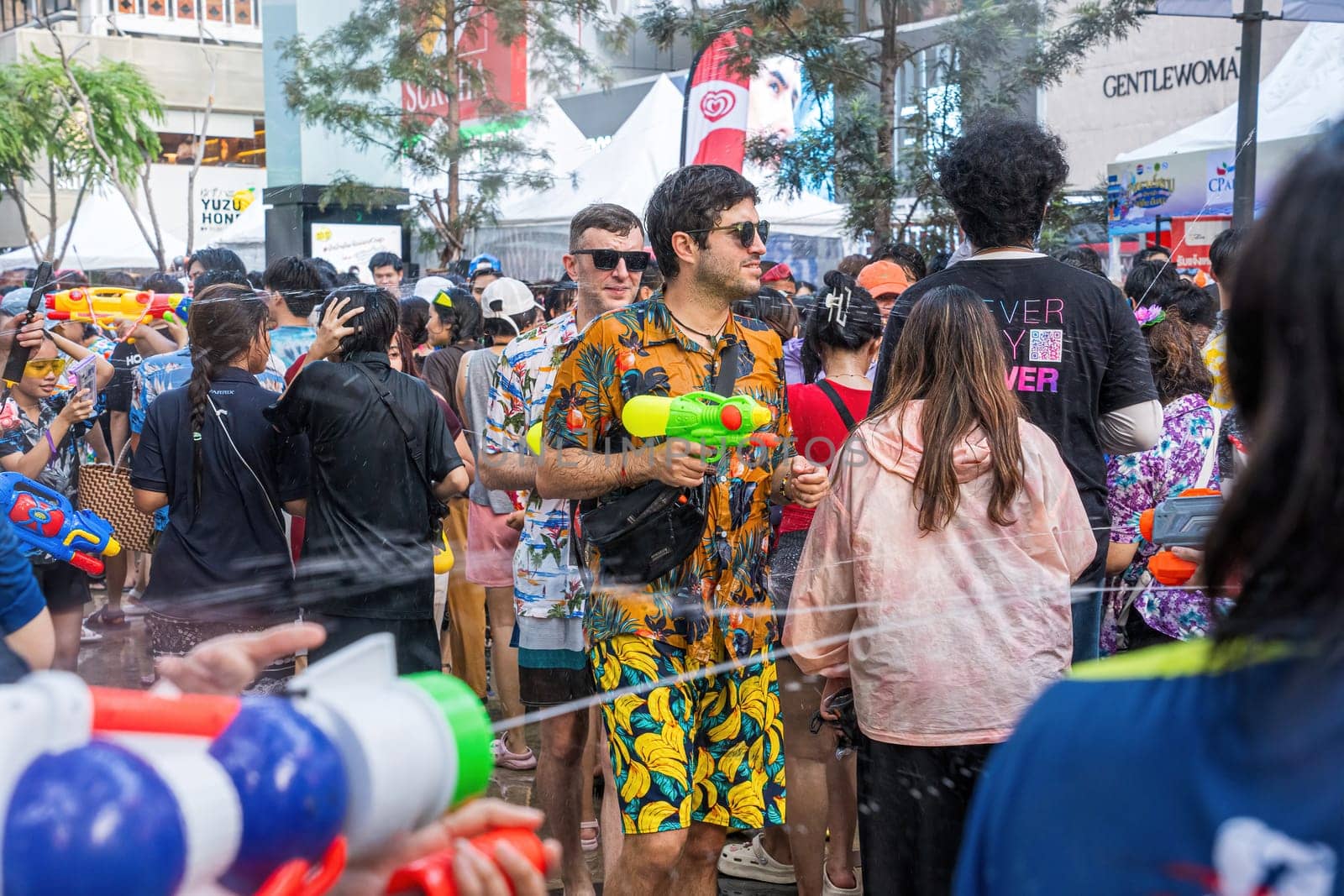 Siam Square, Bangkok, Thailand - APR 13, 2024 Songkran Festival, The short action of people joins celebrations of the Thai New Year or Songkran in Siam Square Bangkok, Thailand.