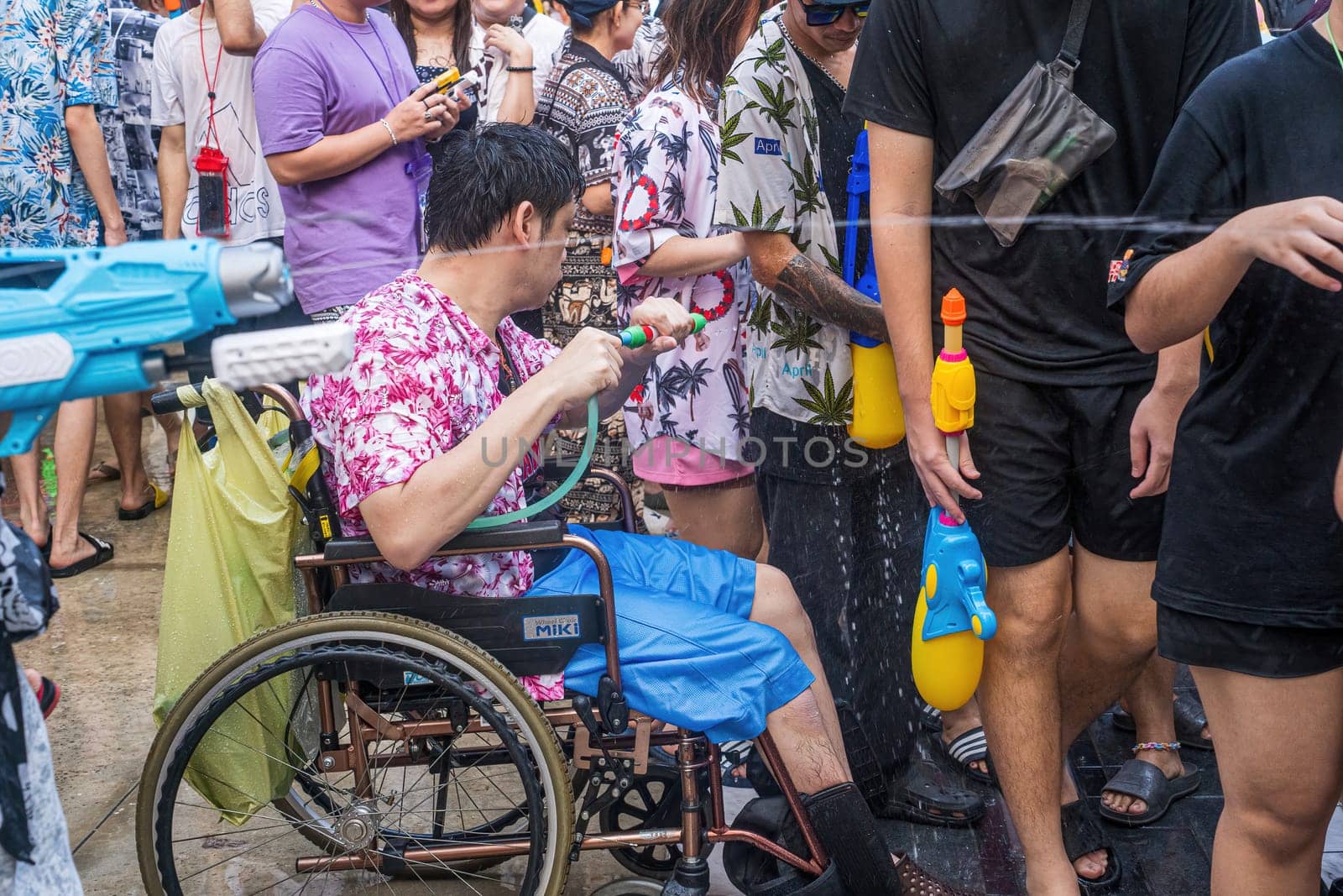 Siam Square, Bangkok, Thailand - APR 13, 2024 Songkran Festival, The short action of people joins celebrations of the Thai New Year or Songkran in Siam Square Bangkok, Thailand.